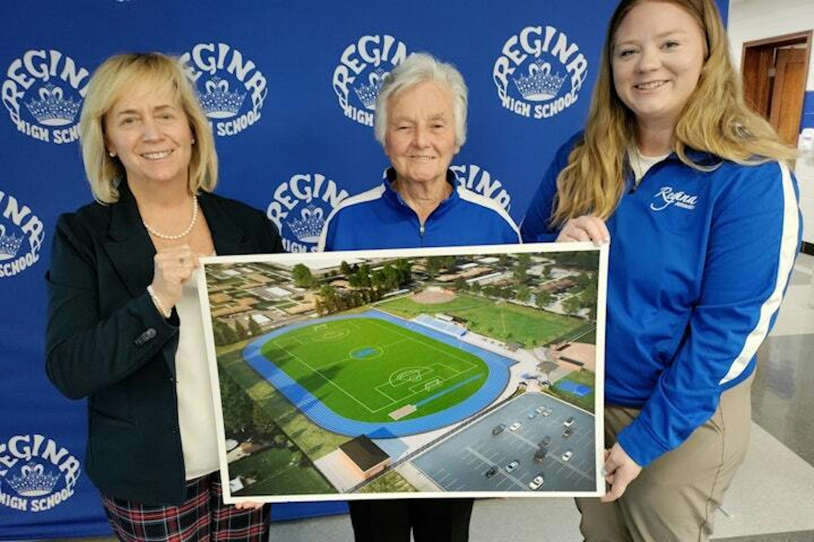 At the announcement a year ago about a $4.5 million project to provide facilities for tennis, track, lacrosse, soccer, field hockey and softball, Mary Treder Lang (left), president of Regina High School, and athletic director Emily Frikken (right) hold a rendering of an athletic complex named in honor of Diane Laffey (center), who served Regina for 52 years as athletic director and coach.