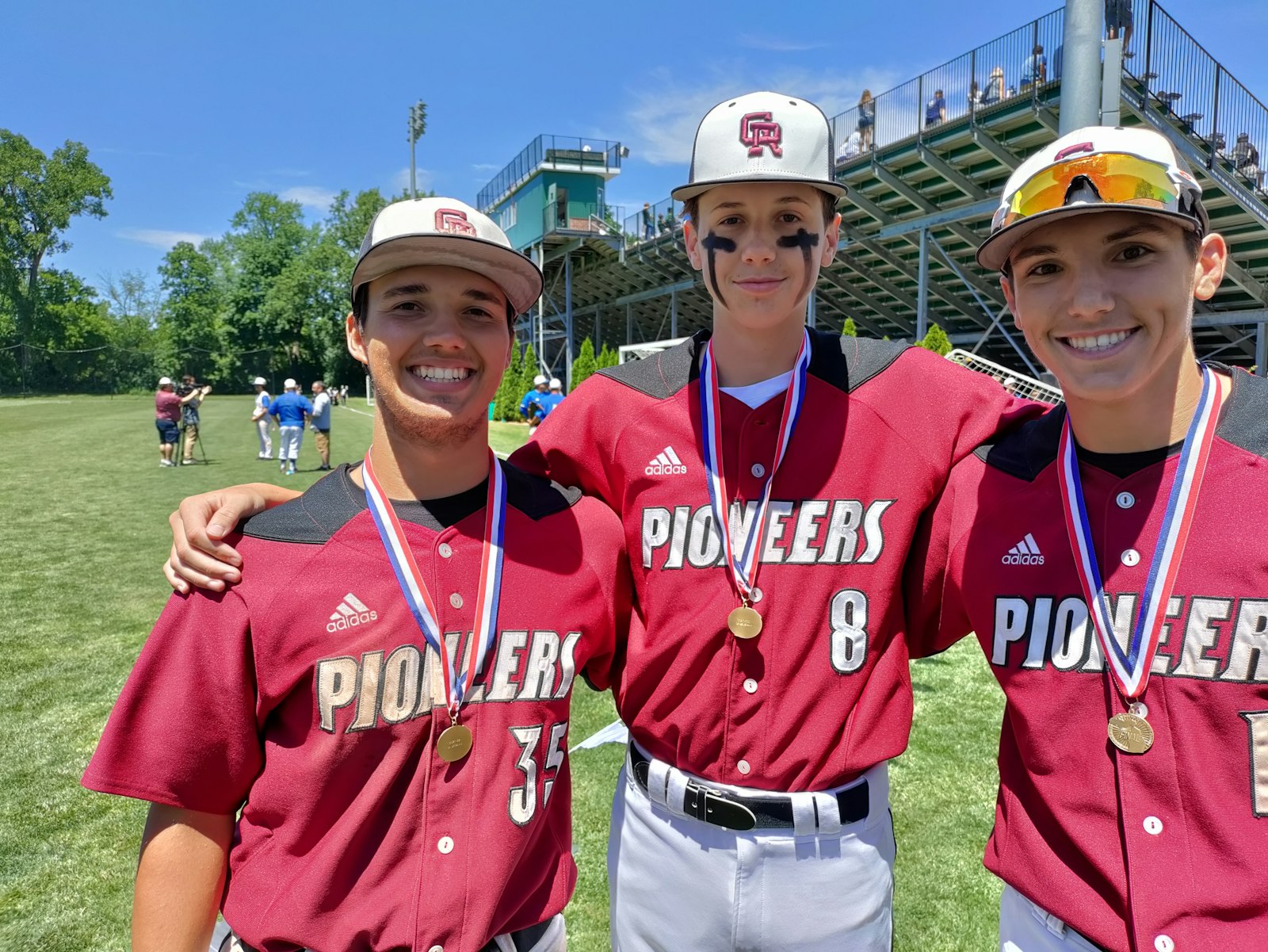 A winning combination: Connor Silka (left) who started the game-winning double play at short, freshman Drew Everingham who came in relief of Ashton Nowak, the winning pitcher, are all smiles about Gabriel Richard’s Division 4 championship.