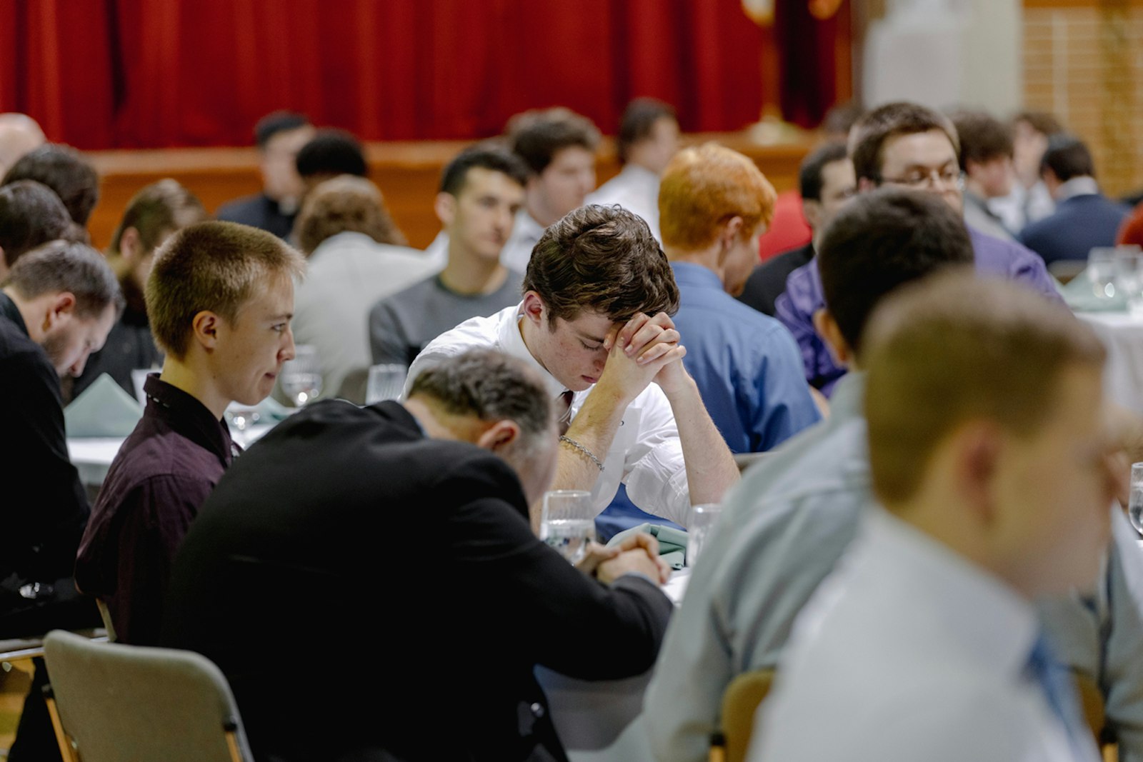 Young men pray during an evening of fellowship, prayer and discernment with seminarians and priests at Sacred Heart Major Seminary in Detroit in February 2024. (Alissa Tuttle | Special to Detroit Catholic)