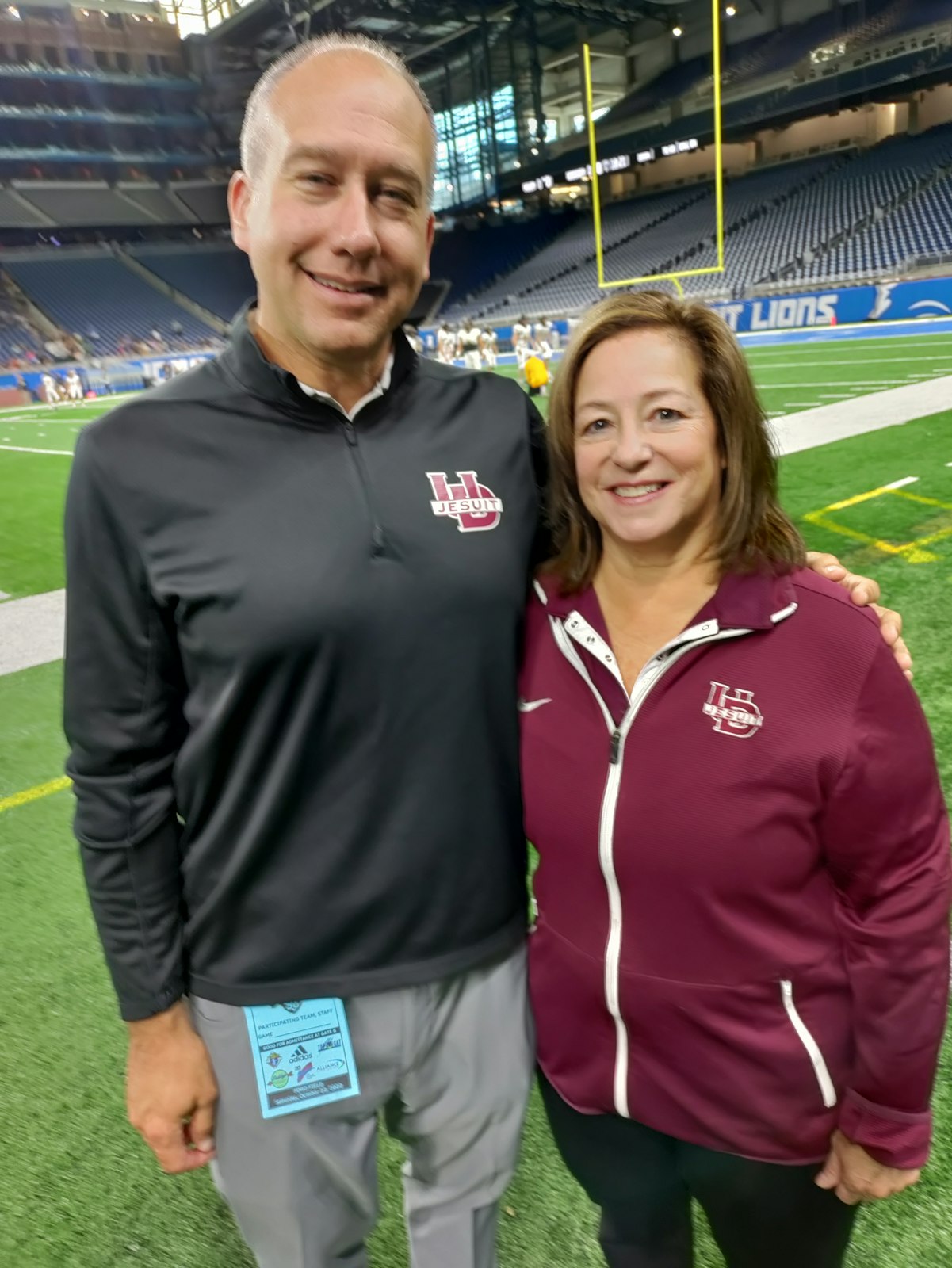 University of Detroit Jesuit Athletic Director Nick Kocsis congratulates Denise Iaquinta for the Administrative Assistant of the Year award.