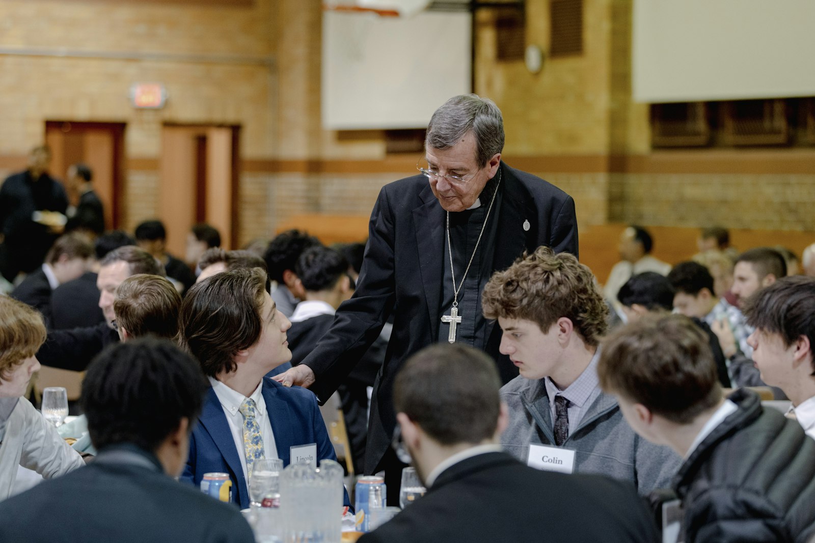 Archbishop Vigneron greets a table of young men gathered at Sacred Heart Major Seminary. The archbishop encouraged those gathered to pray for one another in discerning God's will for their lives.