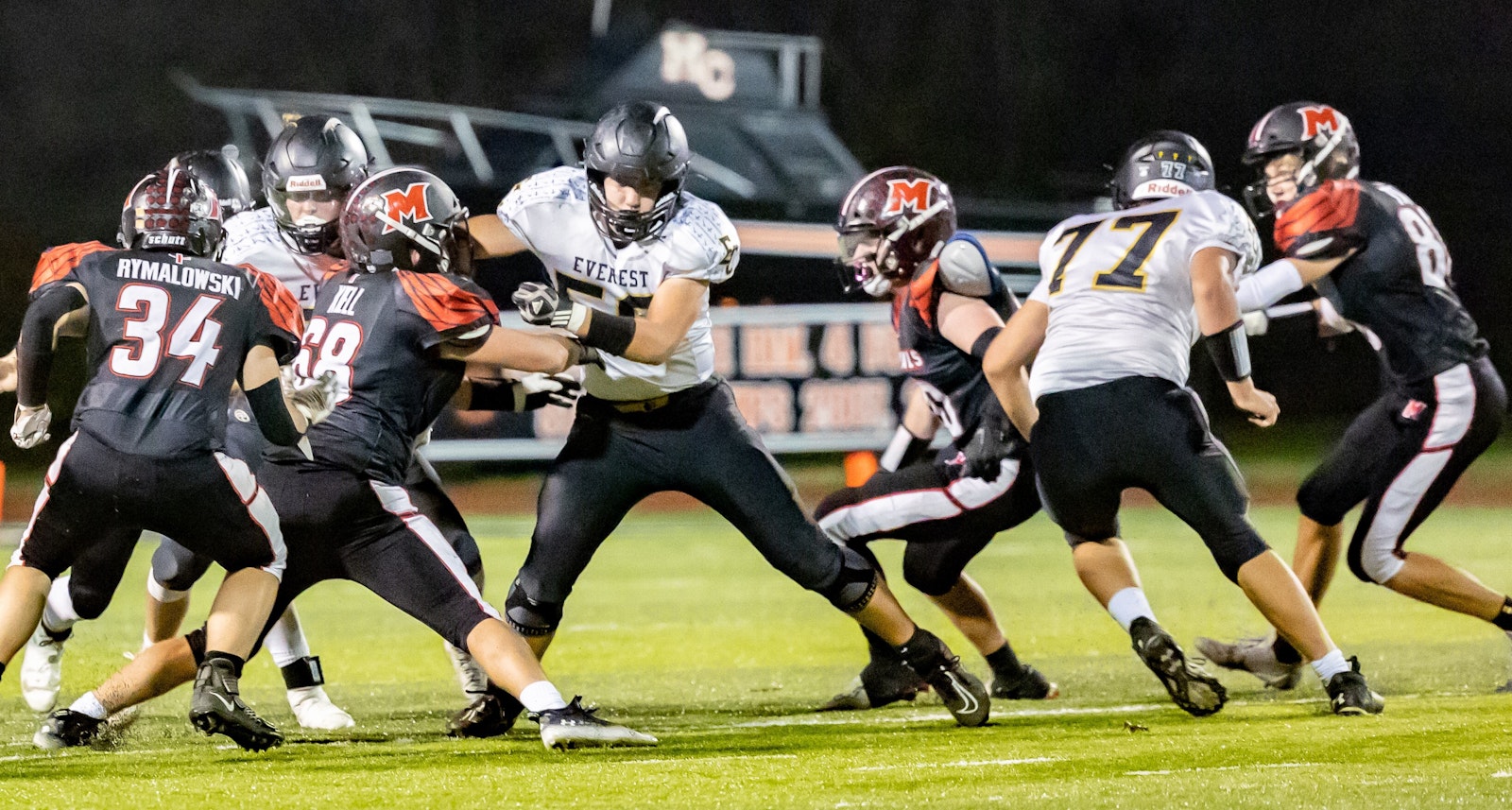 Everest Collegiate linemen Jonathan Brzezinski and Nathan Czach (77) had their hands full fending off Cardinal Mooney tacklers in a Division 8 state playoff game. The Mountaineers defeated the Cardinals to advance to the regional round. (Photo provided by Joseph Brzezinski)