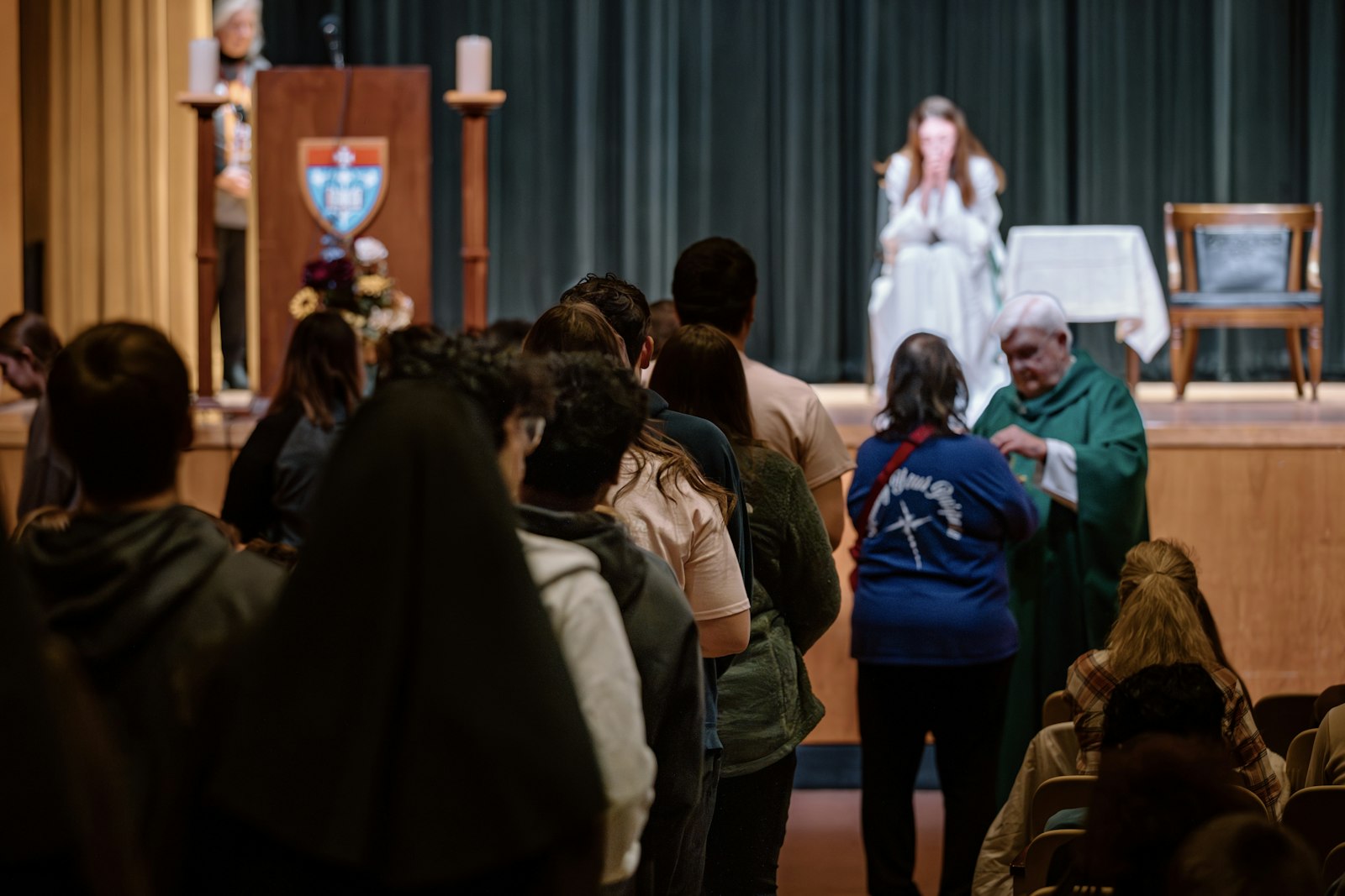 Teens receive Communion during Mass celebrated with Bishop John M. Quinn, retired bishop of Winona-Rochester, Minn., and a former Detroit auxiliary bishop. (Alissa Tuttle | Special to Detroit Catholic)