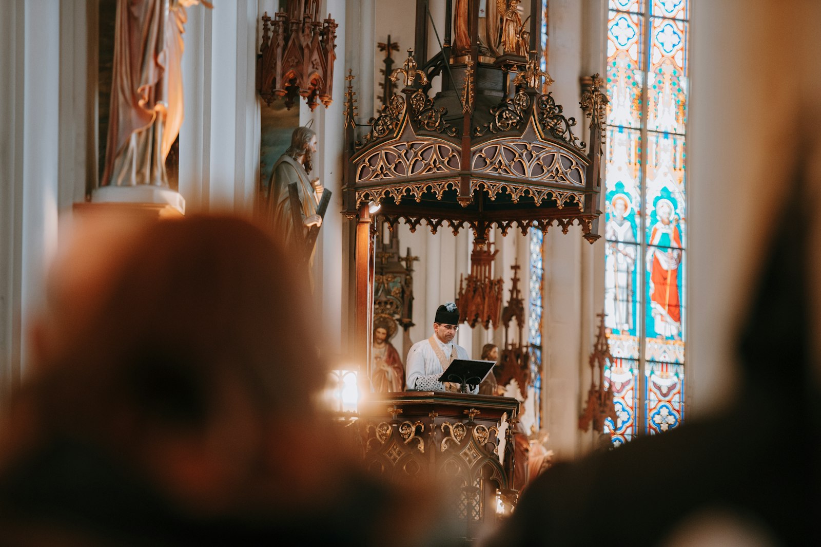 A priest proclaims the Gospel from the pulpit of St. Joseph Shrine in Detroit during a celebration of the extraordinary form Mass.