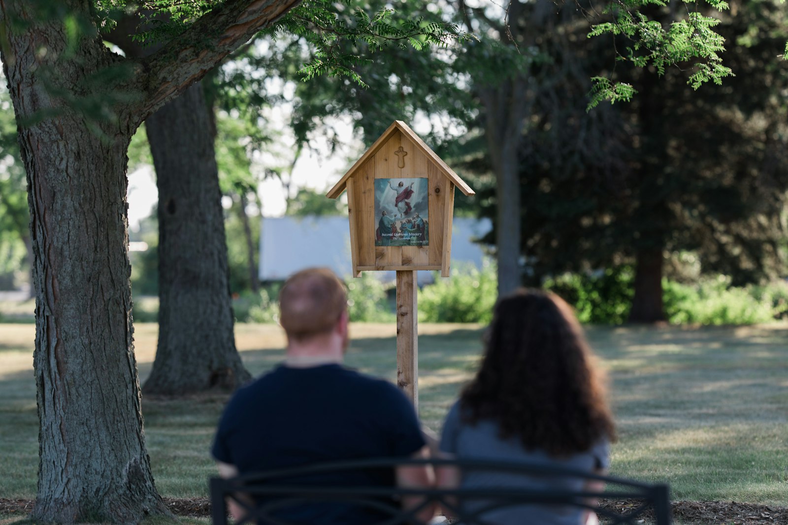 A couple prays at an outdoor Stations of the Cross at Our Lady of Hope Cemetery in Brownstown Township. On All Souls Day, Wednesday, Nov. 2, Archbishop Vigneron will celebrate two Masses while participating in the archdiocese's "Gather Them Home" campaign, which encourages families to bring the cremated remains of loved ones to be buried free of charge in a Catholic cemetery. (Naomi Vrazo | Detroit Catholic)