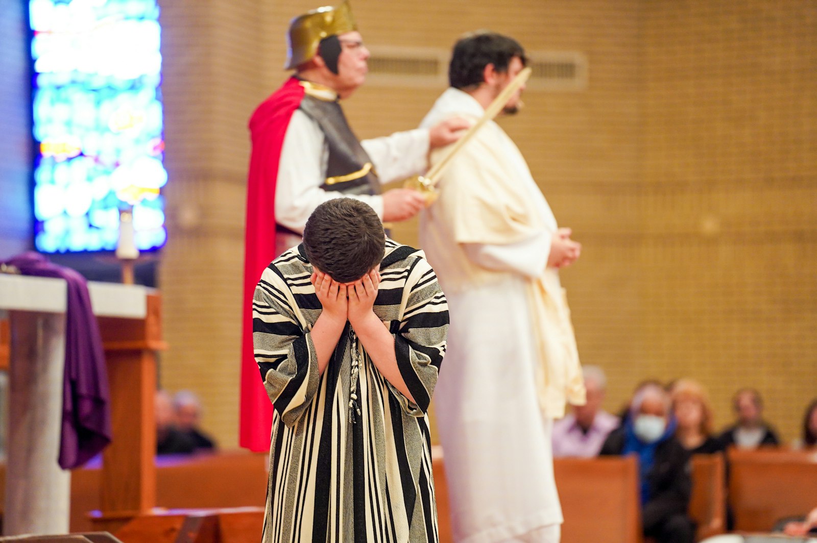 A performer weeps during the Living Stations of the Cross as Jesus, played by Richard Smith, is sentenced.