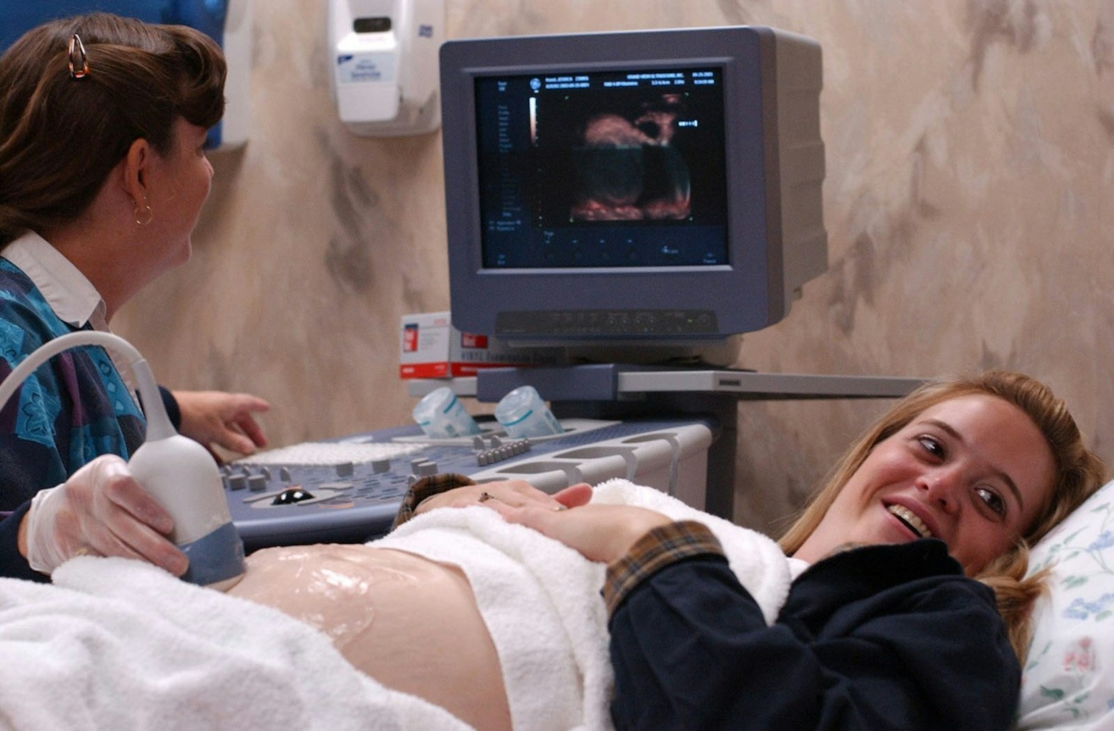 Jessica Kasel of Woodbury, Minn., catches sight of an ultrasound image of her daughter, Emma, on a monitor (out of view) at Grand View Ultrasound in St. Paul. Sonographer Ronda Rosenthal operates the machine, which provides highly detailed images of babies in the womb. (CNS photo by Dave Hrbacek, The Catholic Spirit)