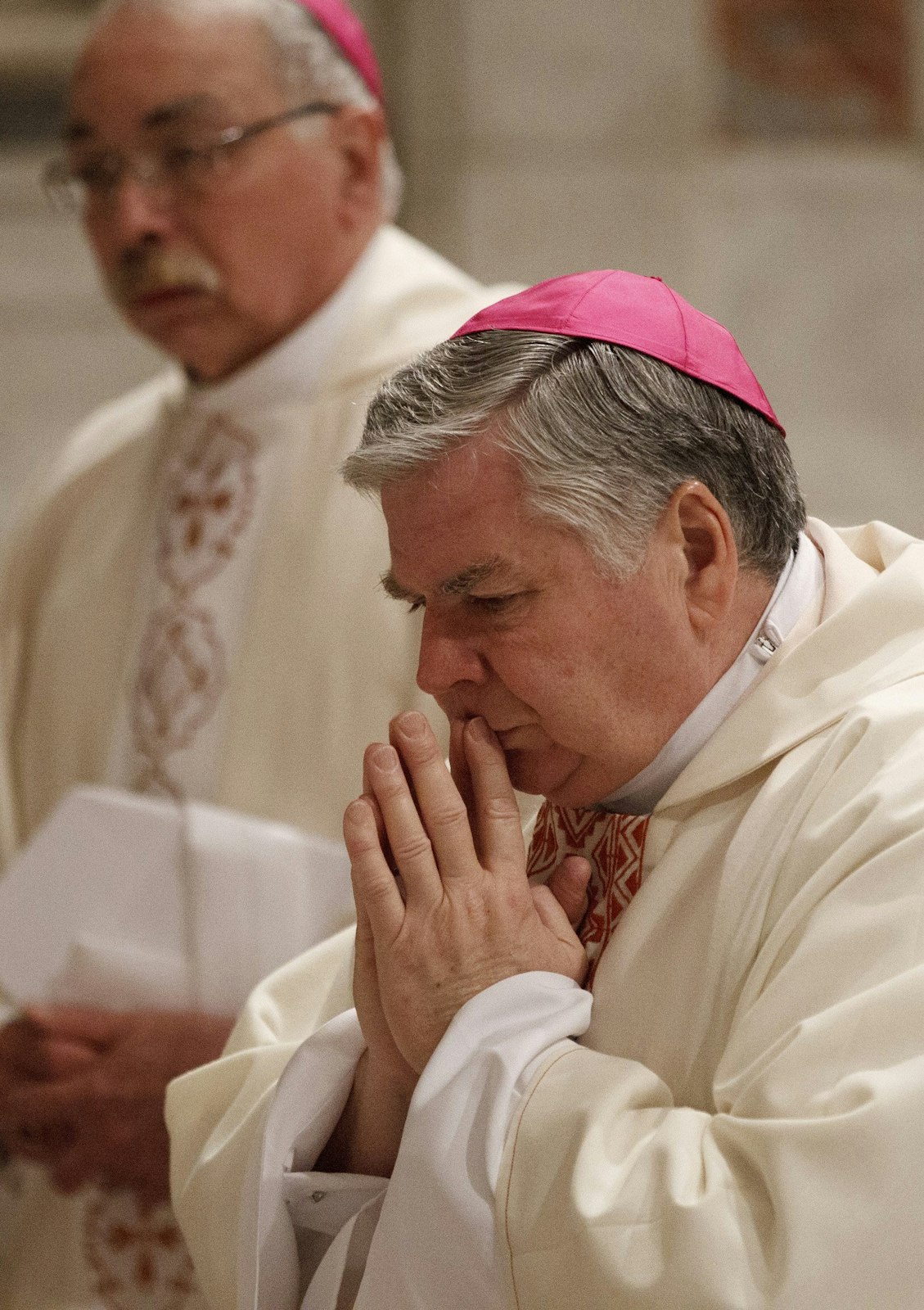 Bishop Paul J. Bradley of Kalamazoo, Mich., prays during a 2012 Mass concelebrated with bishops from Michigan and Ohio on their "ad limina" visits to the Vatican at the tomb of Blessed John Paul II in St. Peter's Basilica. (CNS photo/Paul Haring)