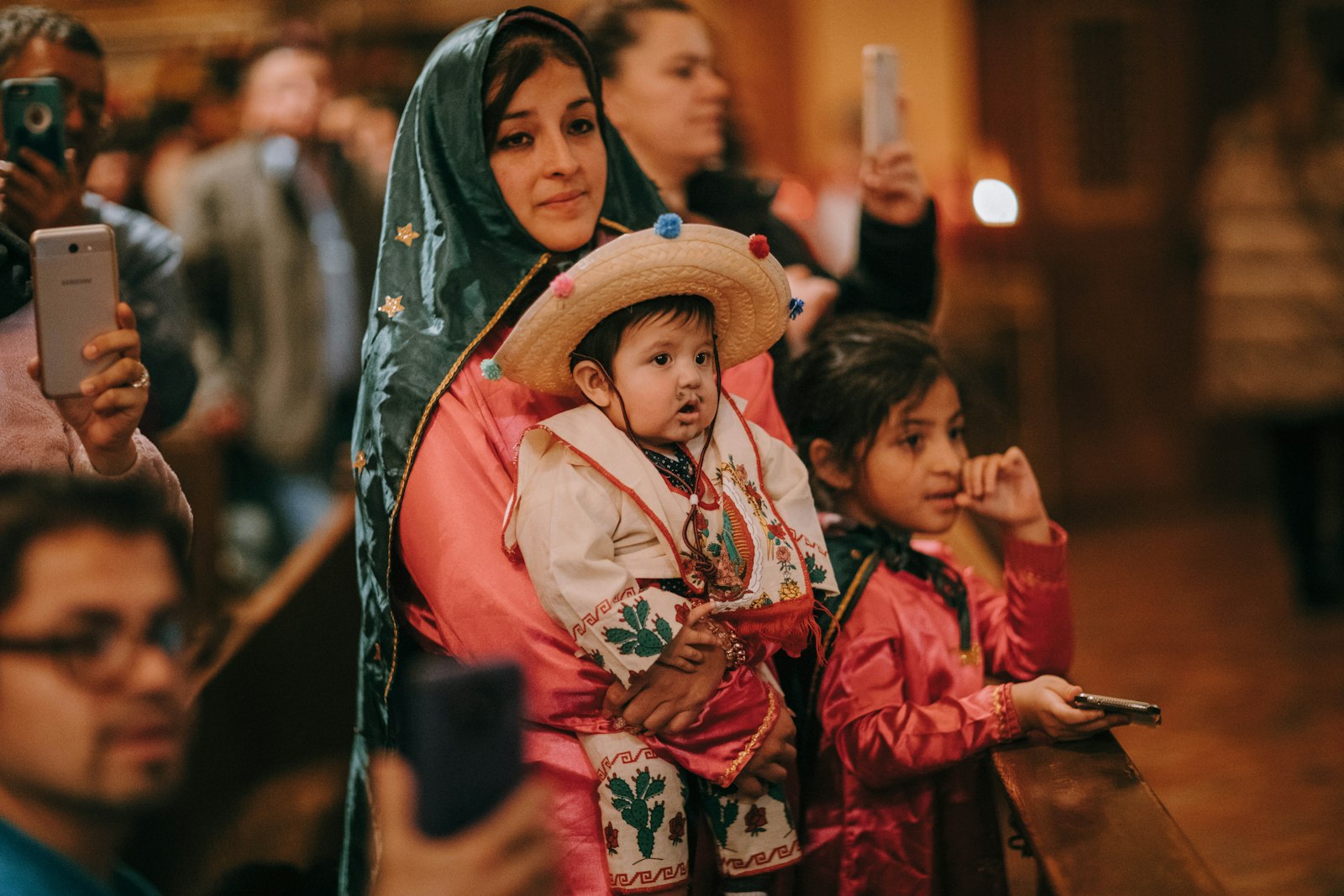 A mother dressed as Our Lady of Guadalupe holds her infant son, dressed as St. Juan Diego, during a celebration of Our Lady of Guadalupe's feast day in 2018 at Holy Redeemer Parish in southwest Detroit. (Naomi Vrazo | Detroit Catholic file photo)