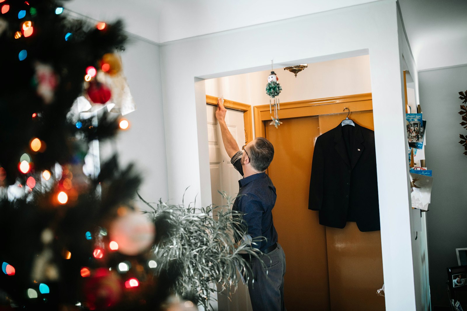 Mike Smigielski, a member of St. Hyacinth Parish in Detroit, marks his family's door with chalk, a traditional part of the celebration of the feast of the Epiphany on Jan. 6. The markings, usually “20 + C + M + B + 24,” are a way for Catholics to show an outward devotion to God, ask His blessings in the new year and to pay homage to the Magi who visited Christ in his first home. The markings signify the first initials of the three wise men, with the numbers representing the year. (Naomi Vrazo | Detroit Catholic)