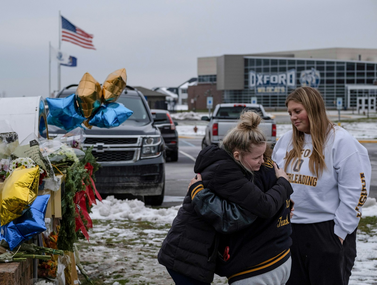 Oxford High School students embrace as they pay their respects at a memorial Dec. 1, 2021, a day after a mass shooting at the school. (CNS photo/Seth Herald, Reuters)
