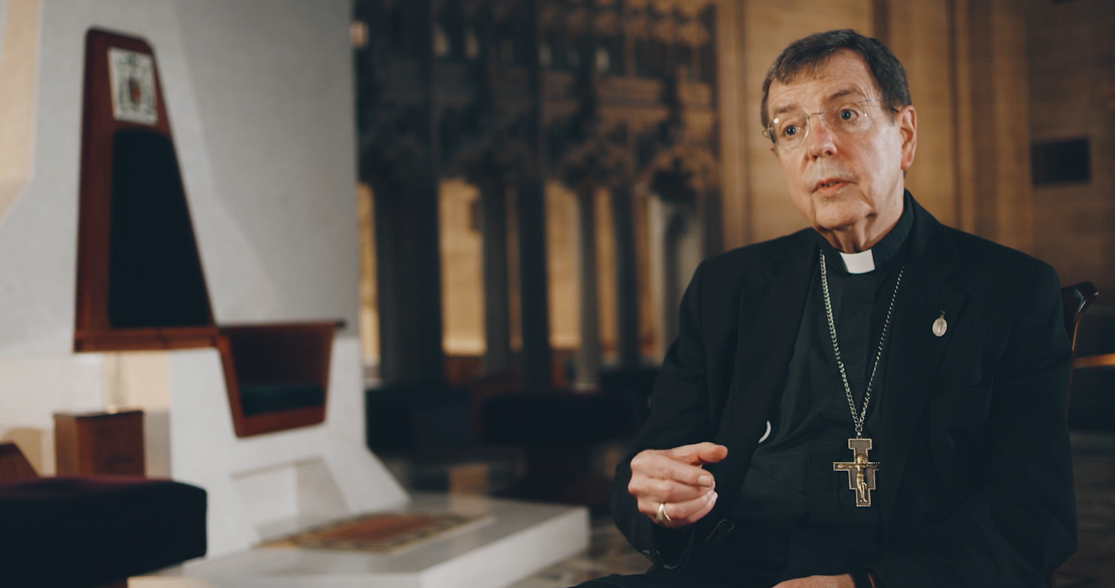 Archbishop Allen H. Vigneron is pictured in a scene from "The Chair," with his cathedra behind him at the Cathedral of the Most Blessed Sacrament. (Screengrab via DeSales Media)