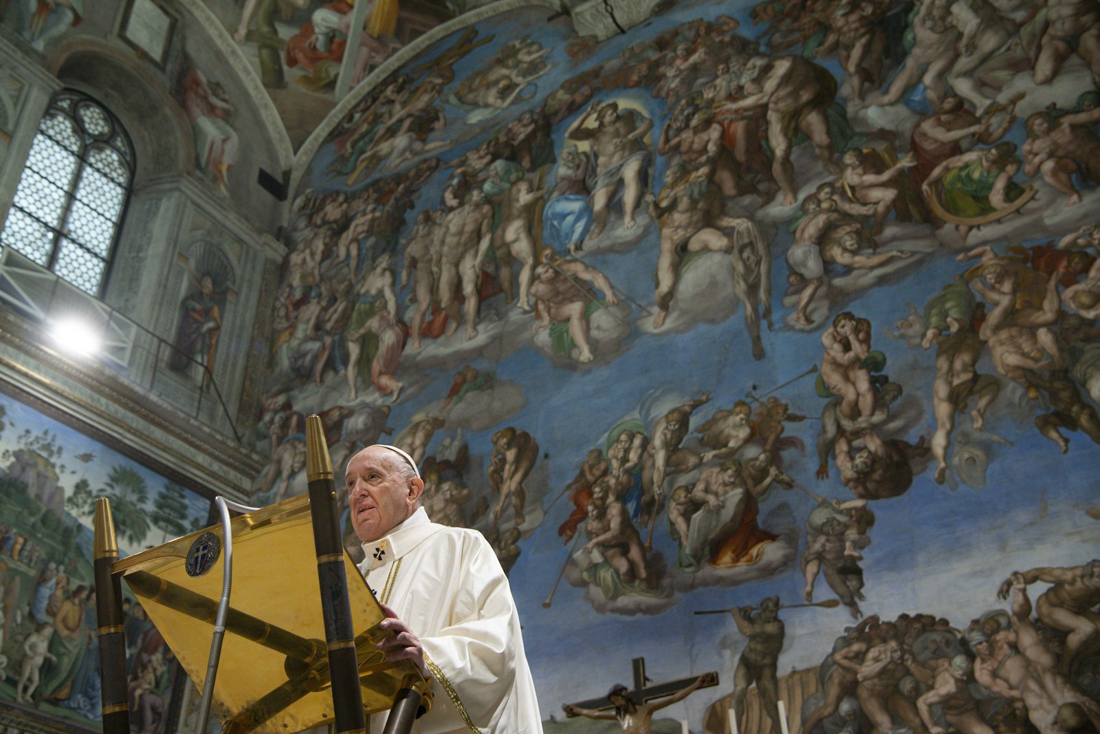 Pope Francis gives a homily in front of Michelangelo's fresco of the "Last Judgment" as he celebrates Mass marking the feast of the Baptism of the Lord in the Sistine Chapel at the Vatican on Jan. 9, 2022. (CNS photo/Vatican Media)