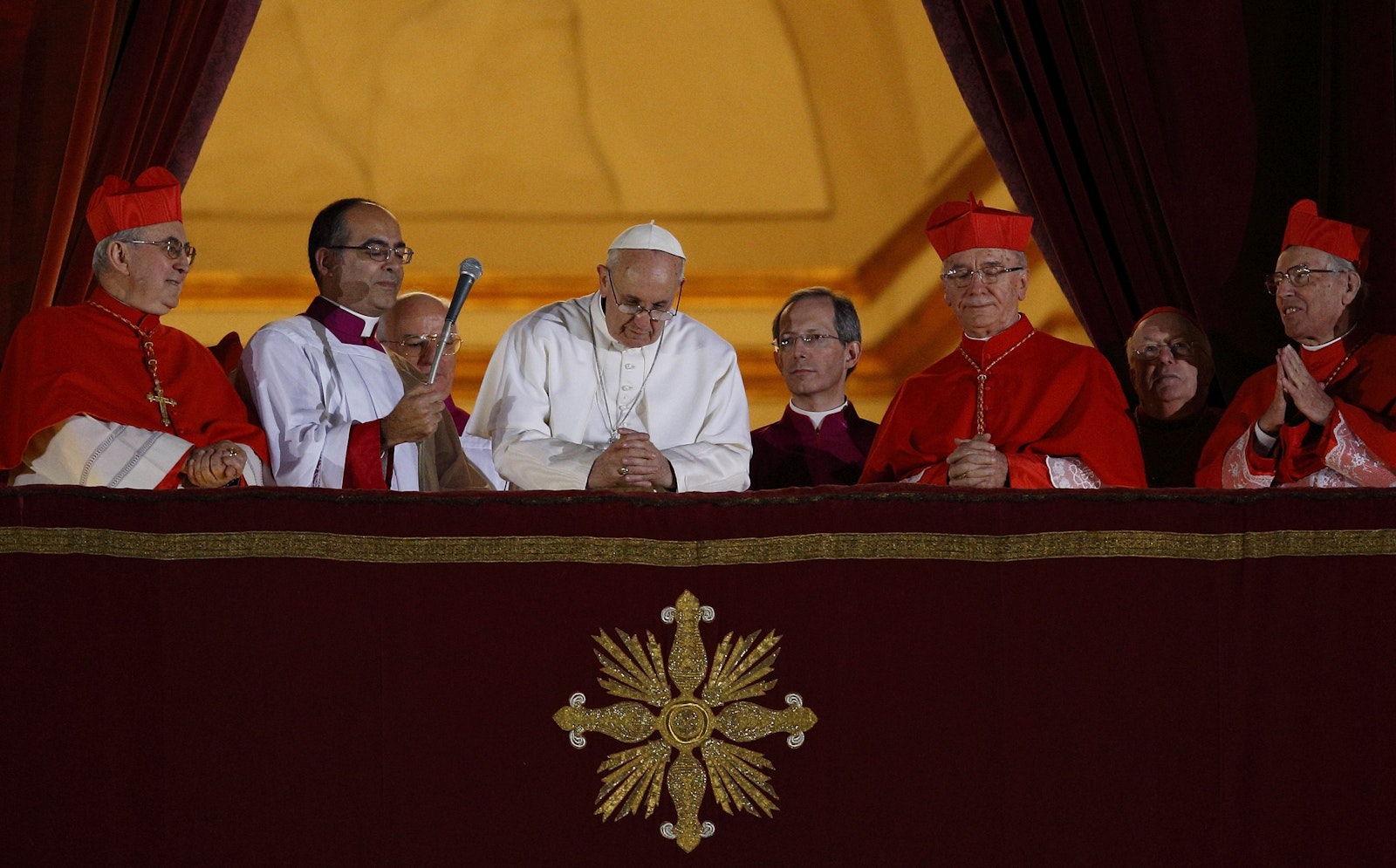 Pope Francis bows his head in prayer during his election night appearance on the central balcony of St. Peter's Basilica at the Vatican on March 13, 2013. Cardinal Jorge Bergoglio's choice of the name "Francis" reflected his devotion to St. Francis of Assisi and served as an early signal of his spirituality and style as his papacy began. (CNS photo/Paul Haring)