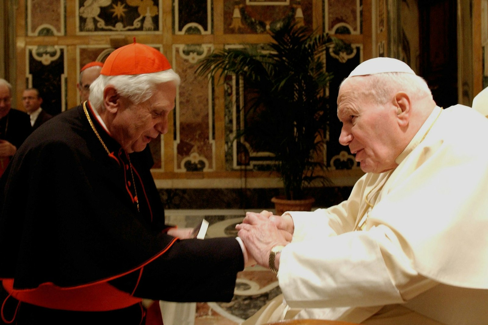 Cardinal Joseph Ratzinger, who later became Pope Benedict XVI, greets Pope John Paul II during a 2004 ceremony at the Vatican. Pope Benedict died Dec. 31, 2022, at the age of 95 in his residence at the Vatican. (OSV News photo/Catholic Press Photo)