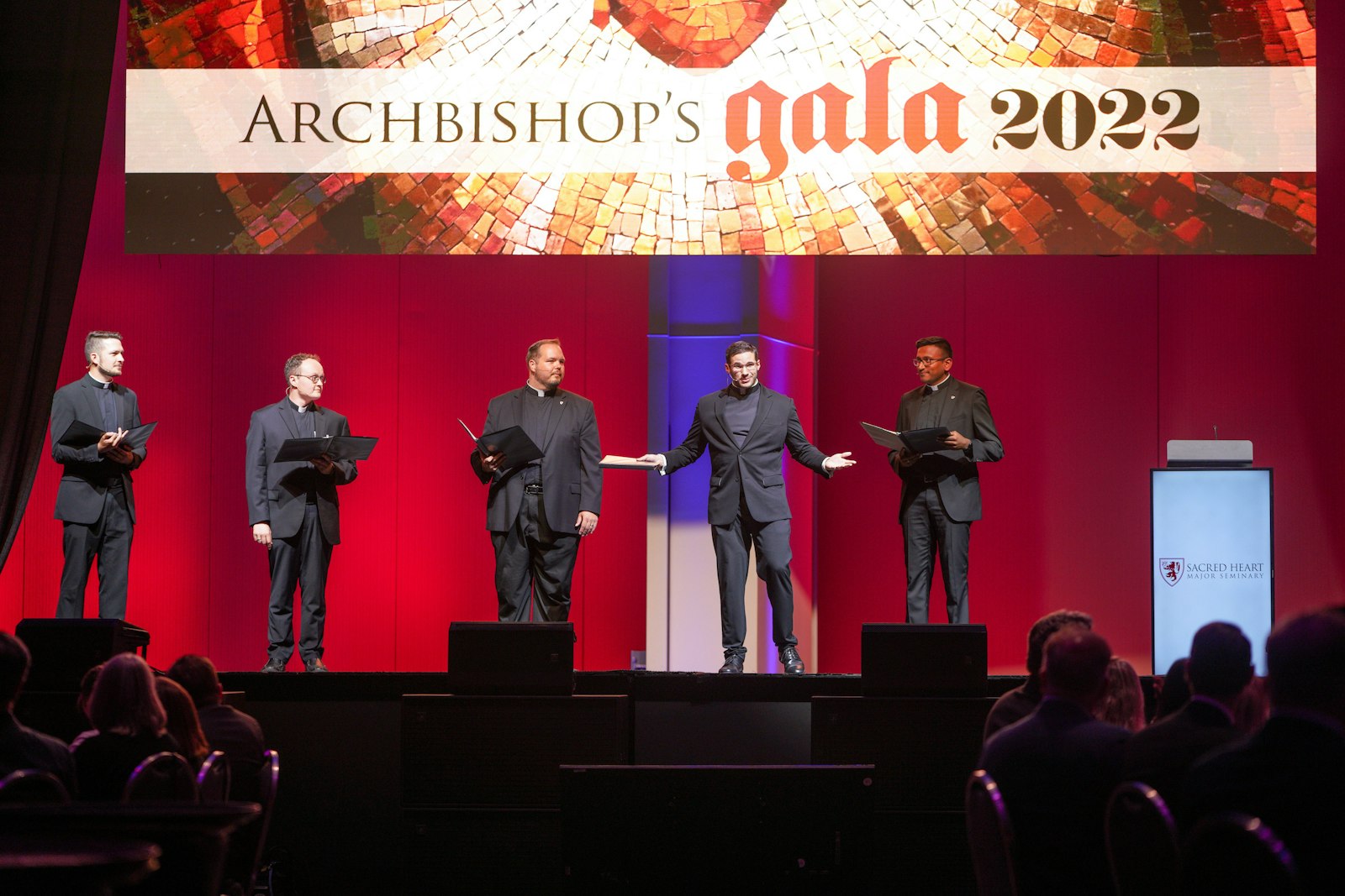Five transitional deacons for the Archdiocese of Detroit served as emcees during the gala, including singing an a capella hymn dedicated to the Sacred Heart of Jesus. From left, Deacons Ryan Walters, Richard Dorsch Jr., Andrew Smith, Jeremy Schupbach and Michael Bruno Selvaraj entertain the crowd of 600 plus during the gala.