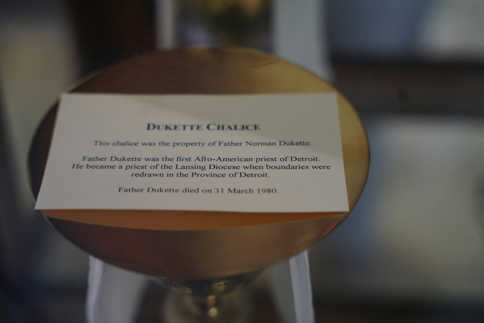 A description is seen with Fr. DuKette's chalice on display at Sacred Heart Major Seminary. (Daniel Meloy | Detroit Catholic)