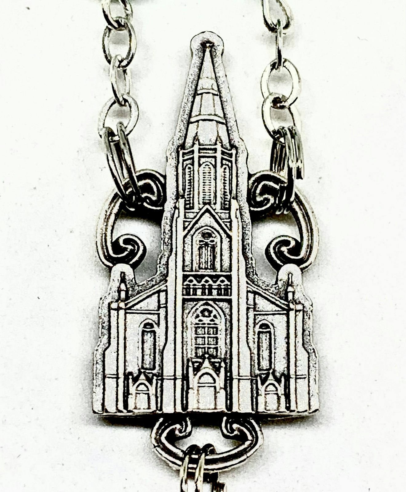 A rosary designed by Ghirelli to commemorate St. Joseph Shrine in Detroit features a cast image of the 150-year-old parish's church on Detroit's east side.