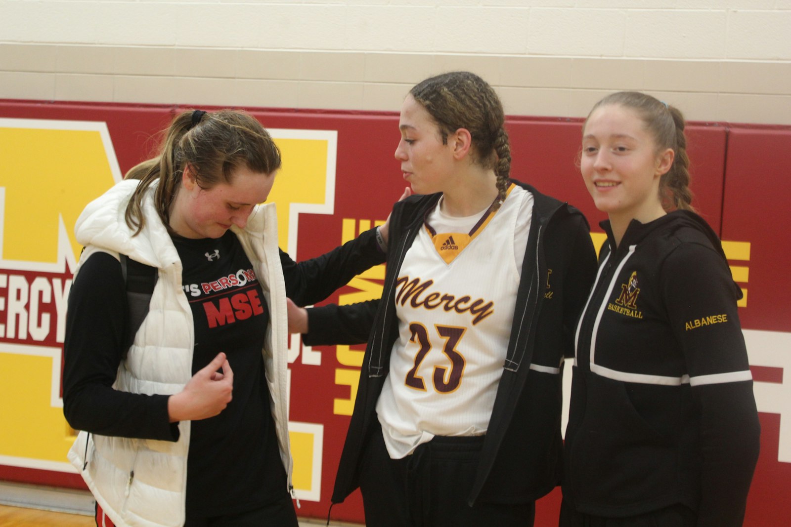 These three players scored a total of 113 points in a single game! Following the contest, Divine Child’s Kennedy Blair (46) talks with Mercy’s Maya White (22) and Aizlyn Albanese (45) about the thrilling overtime battle staged between the two teams on Jan. 24.