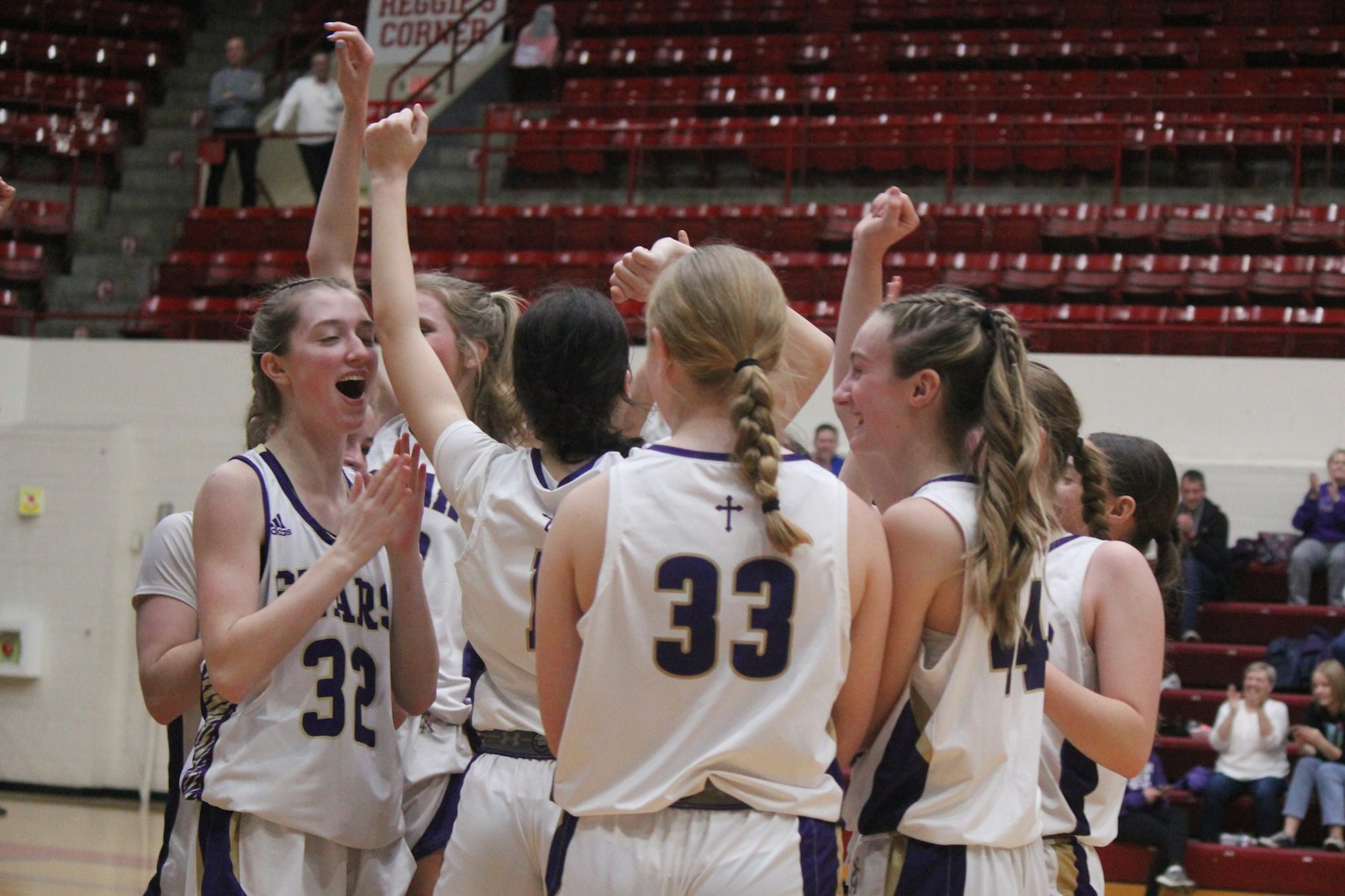 With a big lead in the Cardinal Division championship, Wixom St. Catherine players celebrate during a timeout late in the fourth quarter.