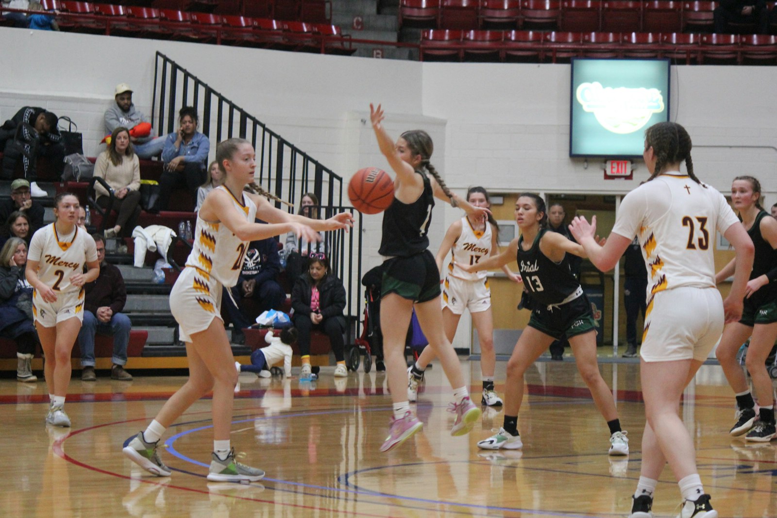 Ann Arbor Fr. Gabriel Richard’s Vanessa Rodriguez tries to knock away a pass from Farmington Hills Mercy’s Aizlyn Albanese to teammate Maya White. The Fighting Irish defense clamped down on Mercy’s shooters and won the Catholic League’s Bishop Division championship, 41-27 on Saturday.