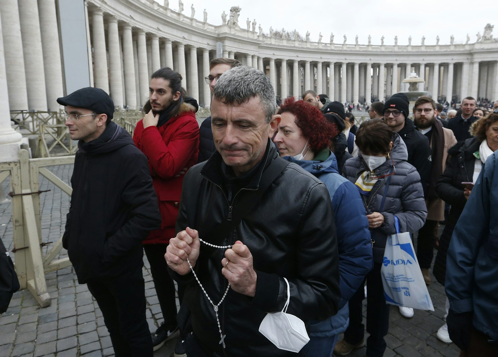 A man holds a rosary as people wait in line to enter St. Peter's Basilica to view the body of Pope Benedict XVI at the Vatican Jan. 2, 2023. (CNS photo/Paul Haring)