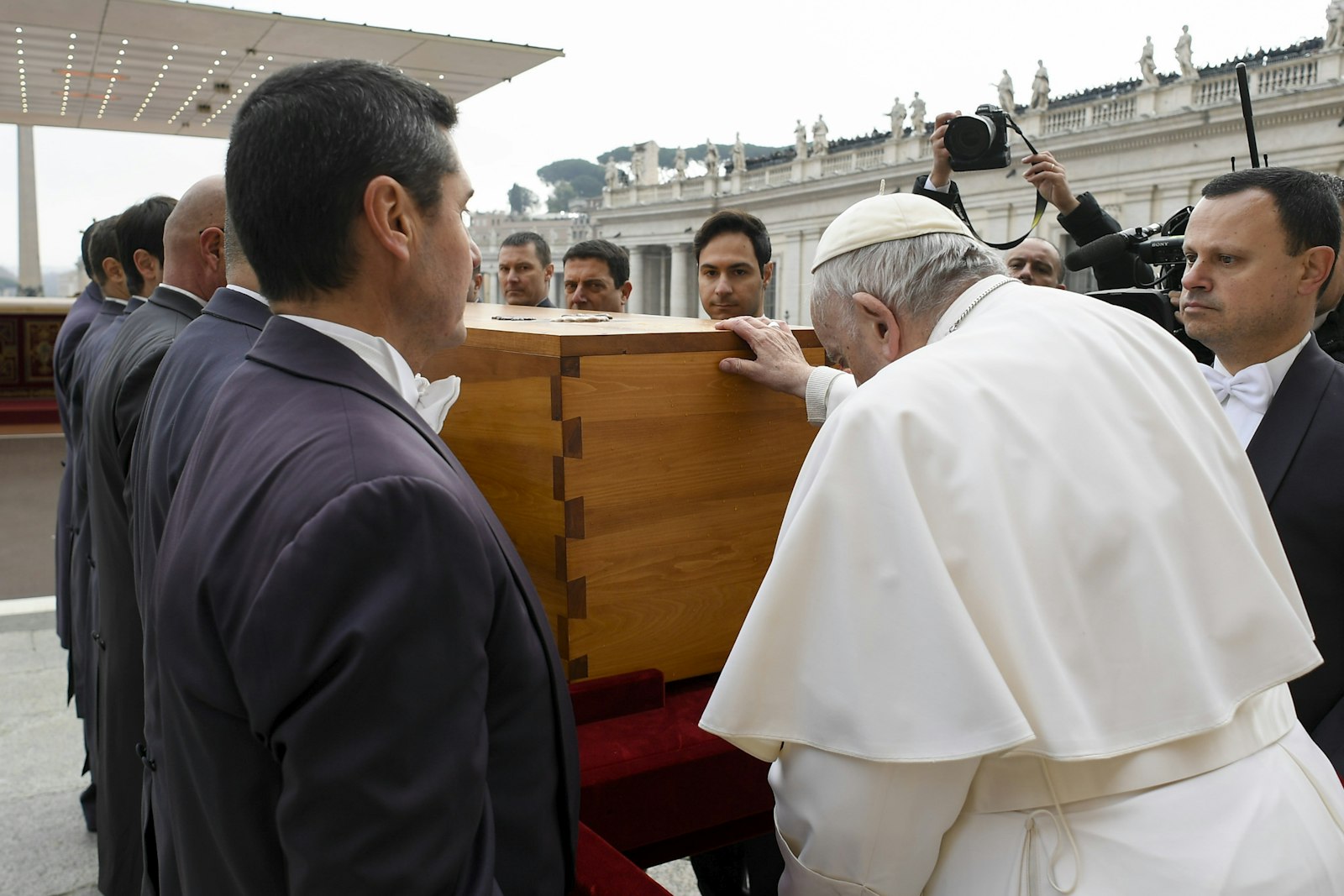 Pope Francis touches the casket of Pope Benedict XVI at the conclusion of his funeral Mass in St. Peter's Square at the Vatican Jan. 5, 2023. (CNS photo/Vatican Media)
