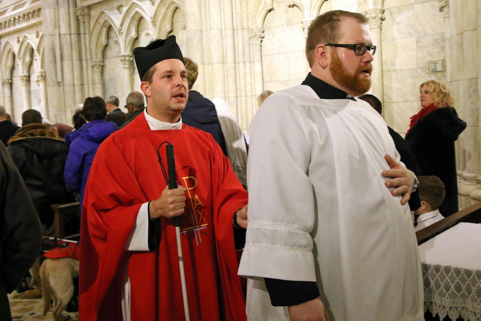 A file photo shows Fr. Jamie Dennis, who is blind and serves in the Diocese of Owensboro, Ky., being assisted by seminarian Chris Kight after celebrating a Mass marking the feast of St. Lucy, patroness of the blind, at St. Patrick's Cathedral in New York City. ((OSV News photo/Gregory A. Shemitz)
