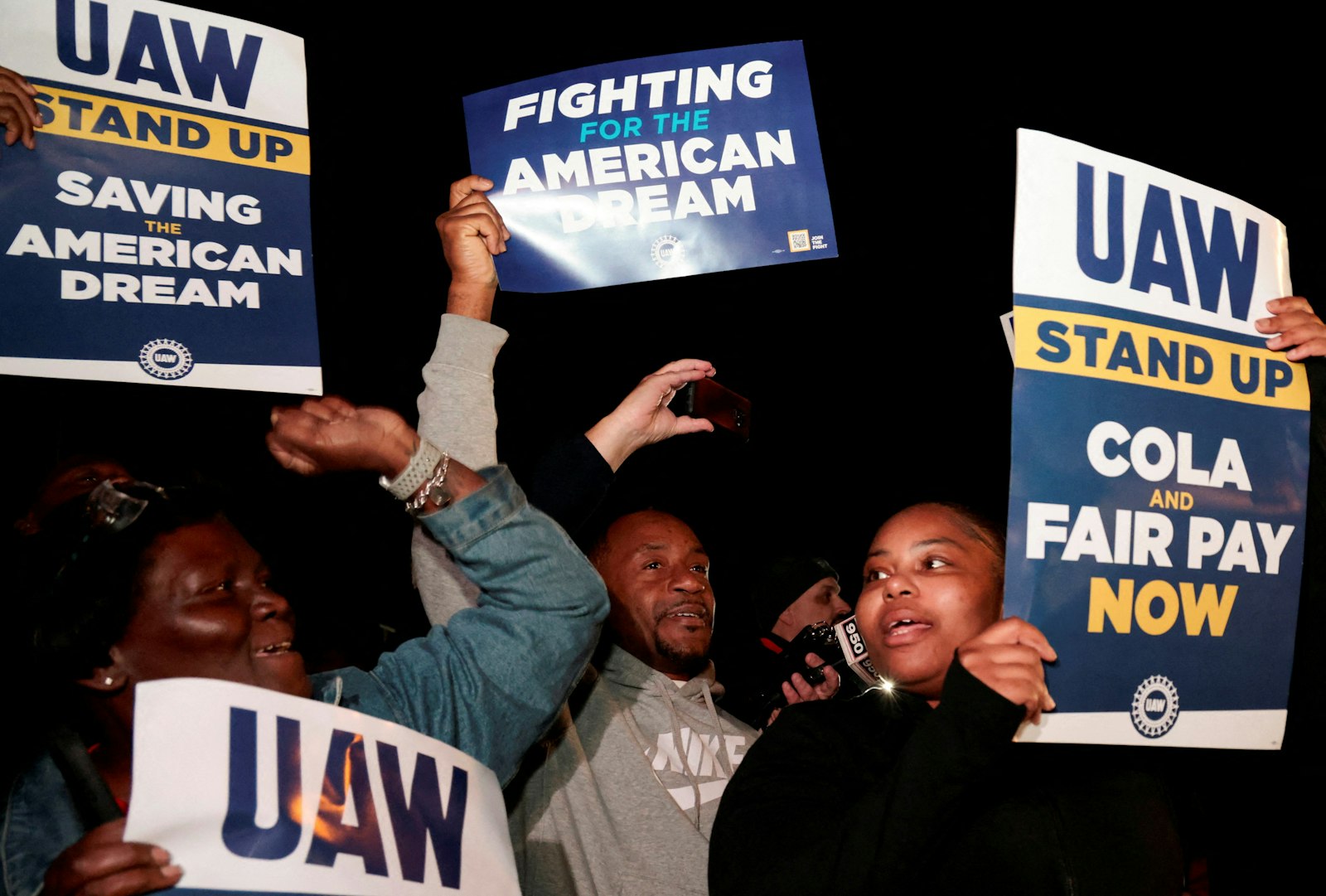 United Auto Workers on strike hold up signs right across from the Ford Michigan Assembly Plant in Wayne, Mich., Sept. 15, 2023. (OSV News photo/Rebecca Cook, Reuters)