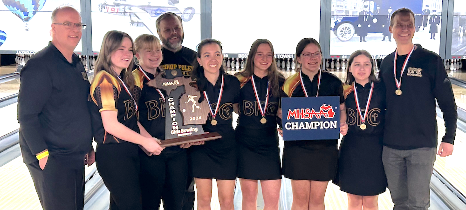 The Madison Heights Bishop Foley girls bowling team won three best-of-five Baker matches to capture the MHSAA’s Division 3 championship, the school’s first in  history. Victory smiles are worn by (from the left) Coach Alan Thibodeau,  senior Isabella Brunt, senior Erica Surratt, Coach Mike Madsen, senior Madelyn Kubacki, sophomore Jacey Thibodeau, freshman Teresa Schudt, freshman Charlotte Grems, and Head Coach Bradford Grems. (Photo courtesy of MHSAA.com)
