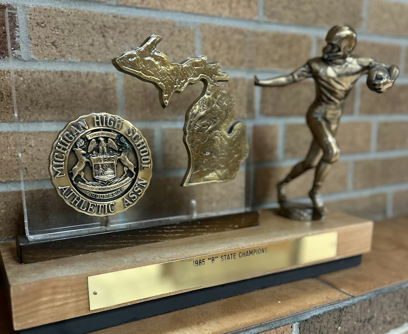 Found one, (temporarily) lost one. Divine Child’s trophy for beating Wyoming Park, 21-0, for the 1985 state Class B football championship is on display at the school. The search is on for the trophy for the state title the Falcons earned in 1975, when the MHSAA football playoff system was implemented. (Photo courtesy of Divine Child)