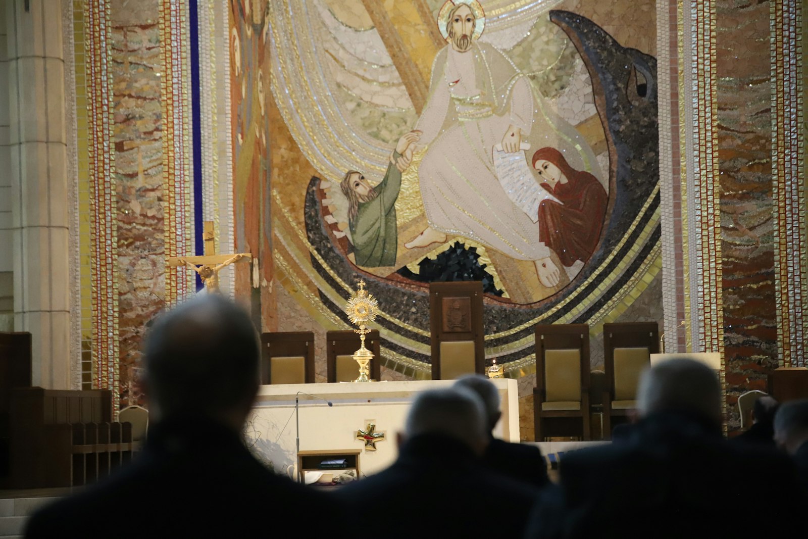 Priests pray in front of a monstrance during a penitential pilgrimage to the Sanctuary of St. John Paul II the Great in Kraków, Poland, Feb. 24, 2024. The sanctuary's main altar is covered with mosaics by Father Marko Rupnik, an artist and ex-Jesuit accused of sexually abusing at least 41 women. (OSV News photo/ courtesy Archdiocese of Krakow Flickr account)