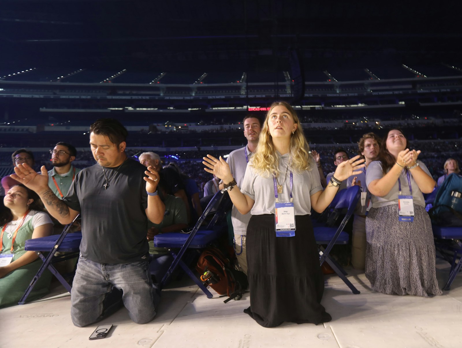 Participants pray during the opening revival night of the National Eucharistic Congress at Lucas Oil Stadium in Indianapolis July 17, 2024. (OSV News photo/Bob Roller)