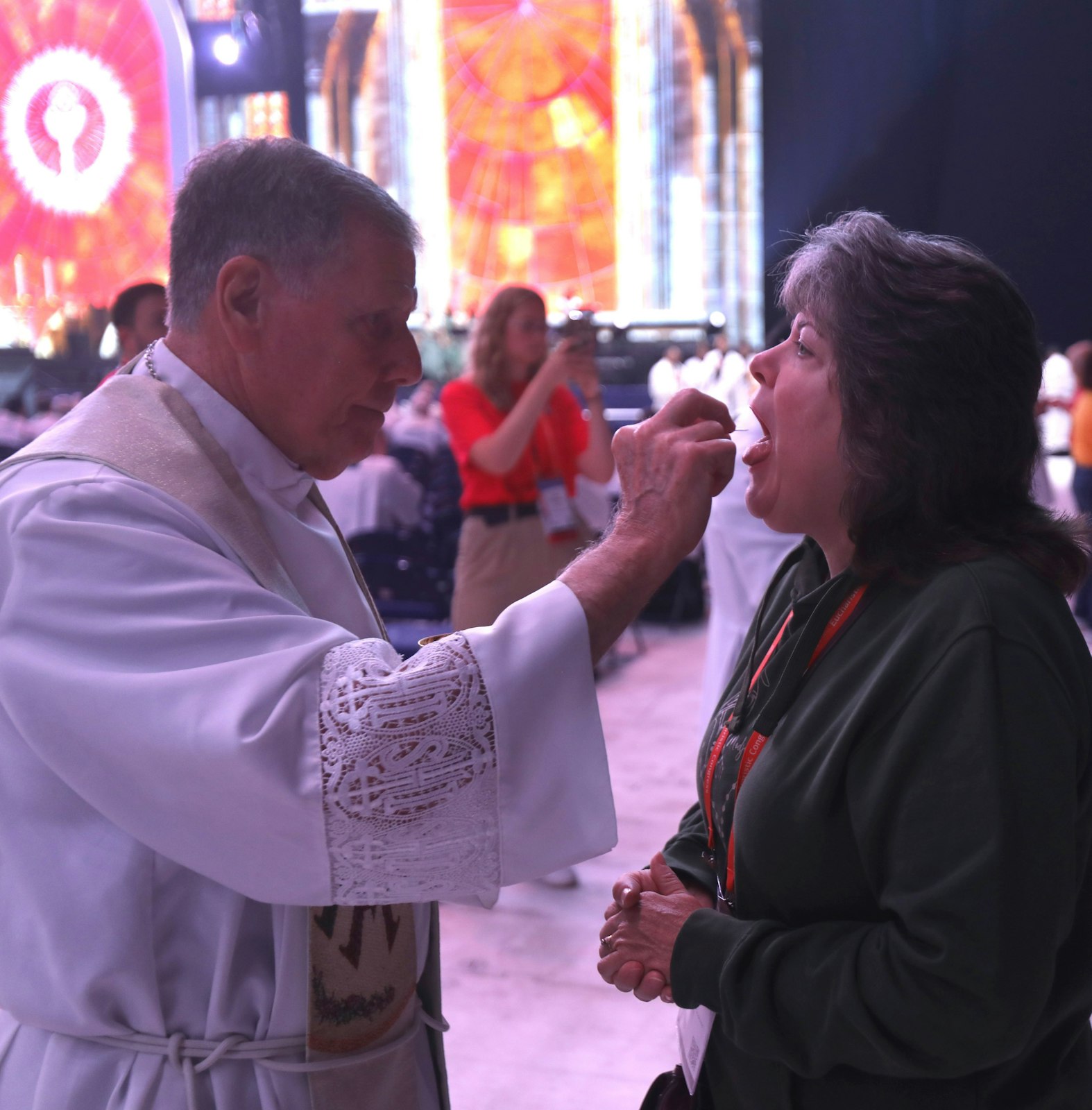 A pilgrim receives Communion during Holy Qurbana July 20, 2024, at Lucas Oil Stadium in Indianapolis during the National Eucharistic Congress. Holy Qurbana is the name for Mass in the Catholic Church's Syro-Malabar rite. (OSV News photo/Bob Roller)