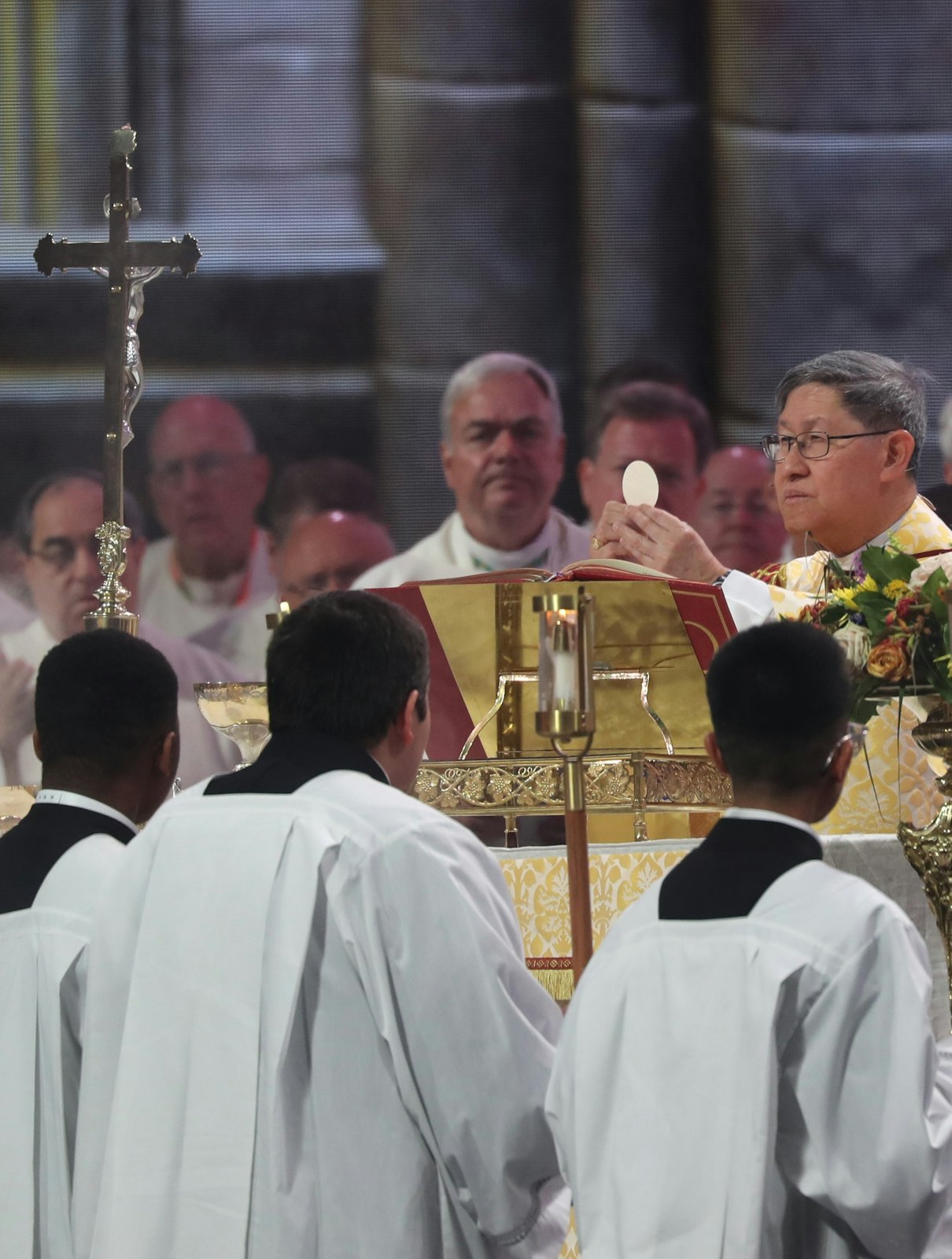 Cardinal Luis Antonio Tagle, pro-prefect of the Dicastery for Evangelization’s Section for First Evangelization and New Particular Churches, raises the host July 21, 2024, during the final Mass of the National Eucharistic Congress at Lucas Oil Stadium in Indianapolis. (OSV News photo/Bob Roller)