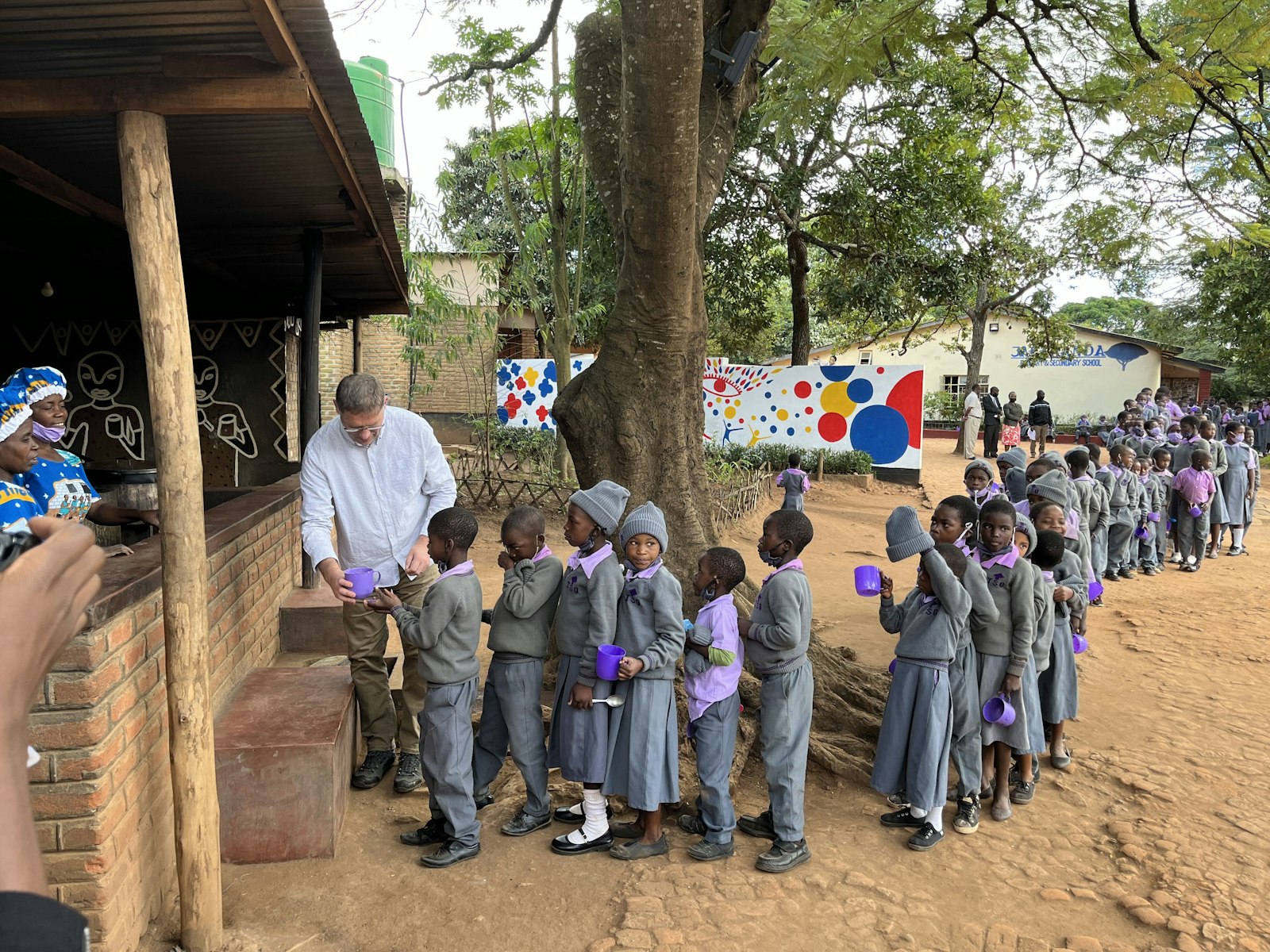 Magnus MacFarlane-Barrow, founder of Mary's Meals, is seen in a 2022 photograph serving school meals to Jacaranda Primary and Secondary School in Malawi. The charity started in 2002 with meal distribution to 200 children in two primary schools in that very countryi. Today, Mary's Meals serves meals to 2,429,182 children every school day across 17 countries. (OSV News photo/Graeme Little's Kenya Trip Photos, courtesy Mary's Meals)