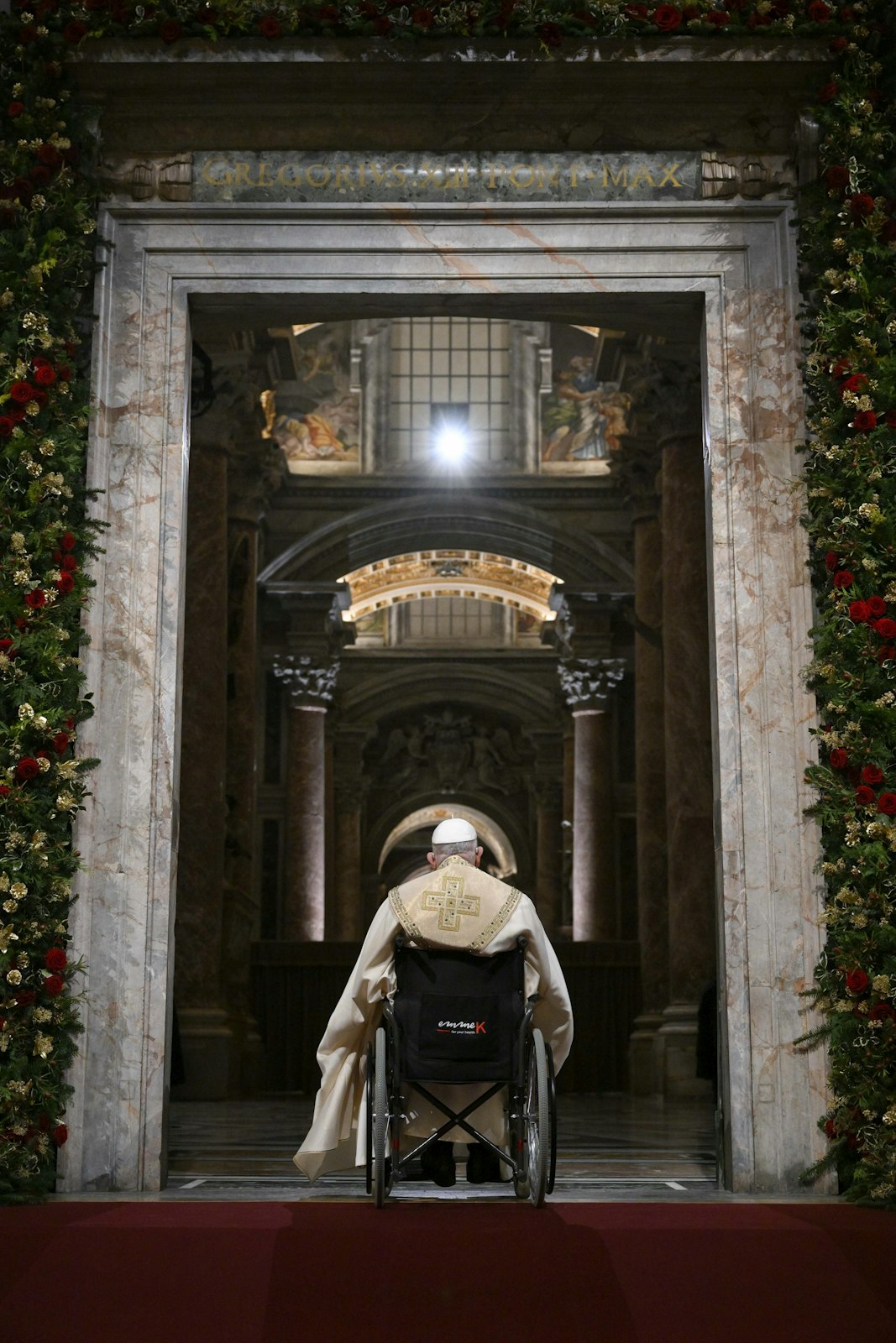 Pope Francis pauses in prayer on the threshold of the Holy Door of St. Peter's Basilica at the Vatican Dec. 24, 2024, after he opened it and inaugurated the Holy Year 2025. (CNS photo/screen grab, Vatican Media)