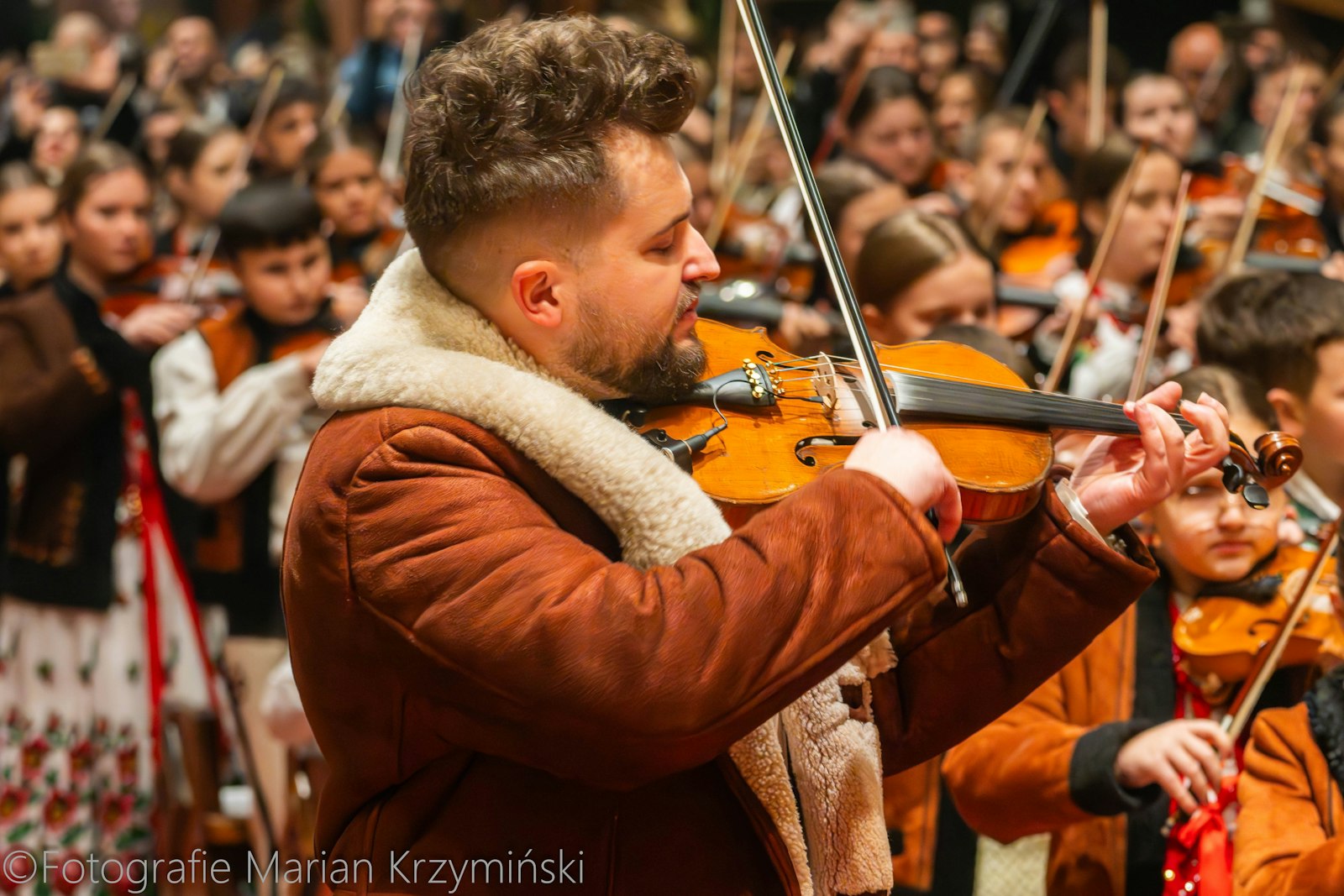 Damian Palasz, founder of the children's orchestra "Mala Armia Janosika" ("The Little Army of Janosik"), is pictured on Dec. 25, 2024, in Rabka-Zdrój, southern Poland. The orchestra's performance of a Christmas carol has gone viral, bringing little highlanders into the global spotlight. The performance took place during the midnight Mass at St. Mary Magdalene Church in Rabka-Zdrój. The orchestra was founded in 2015. (OSV News photo/courtesy Marian Krzyminski)