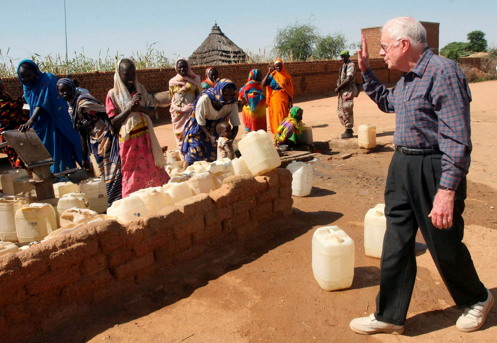 Former U.S. President Jimmy Carter from the Elders Group waves to internally displaced women at a water point in Kebkabiya town in North Darfur, Sudan, Oct. 3, 2007. Carter died Dec. 29, 2024, at 100, at his home in Plains, Georgia. (OSV News photo//Mohamed Nureldin Abdalla, Reuters)