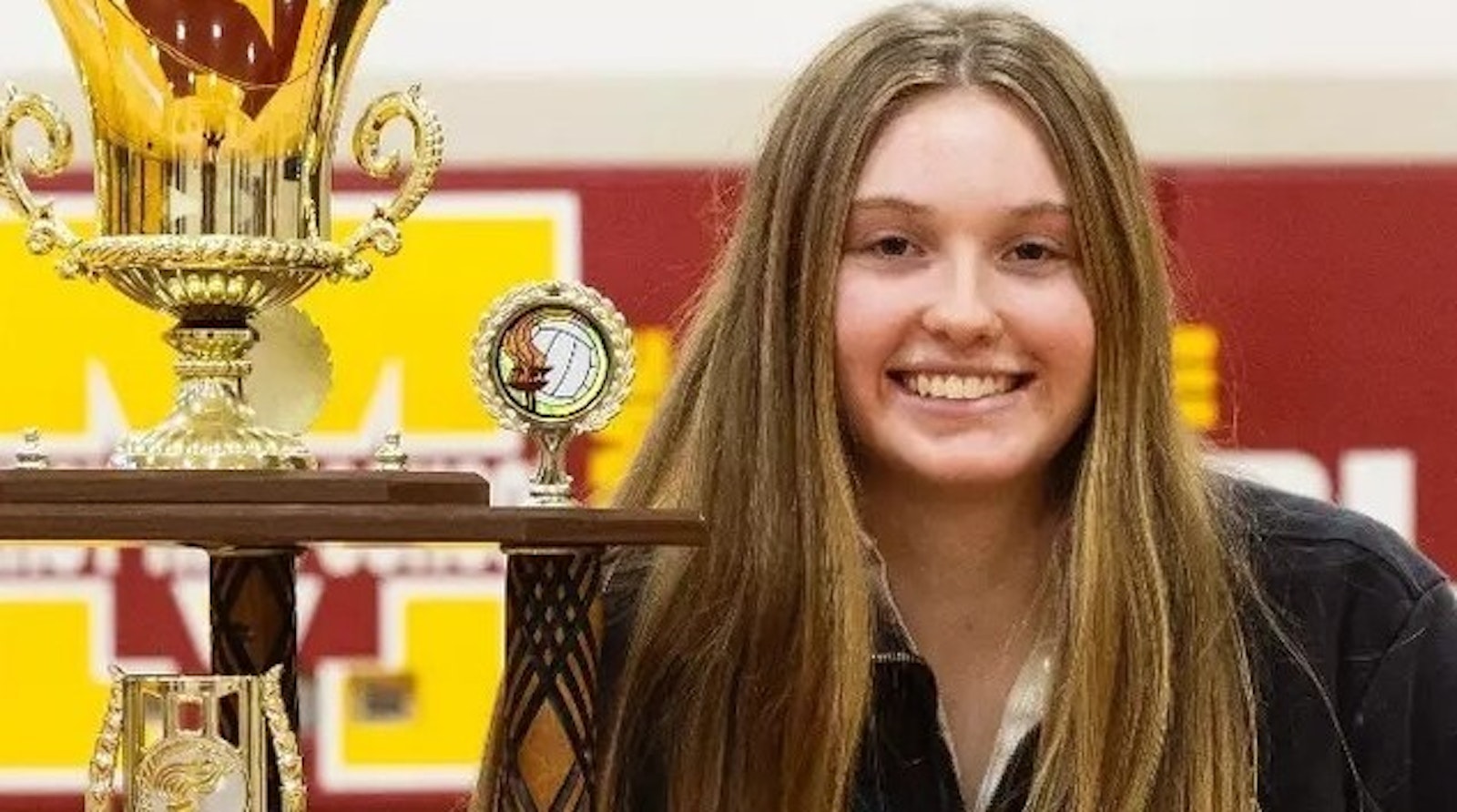 Mercy’s Campbell Flynn, alongside her Miss Volleyball trophy, will be enrolling this month to begin a career at the University of Nebraska after successfully cramming the past semester the courses required for her high school graduation. (Photo courtesy Farmington Hills Mercy)