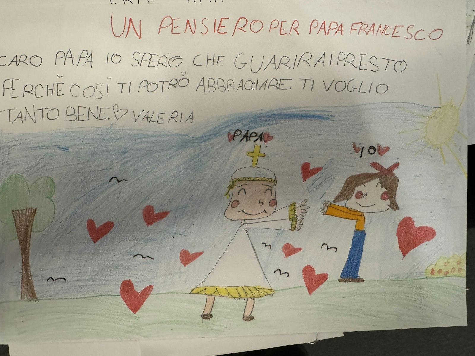 A girl named Valeria sends Pope Francis a card saying she hoped he would get well soon so that she could give him a hug. The Vatican press office brought the card from Pope Francis' room at Rome's Gemelli hospital Feb. 23, 2025, for reporters to see. (CNS photo/Cindy Wooden)