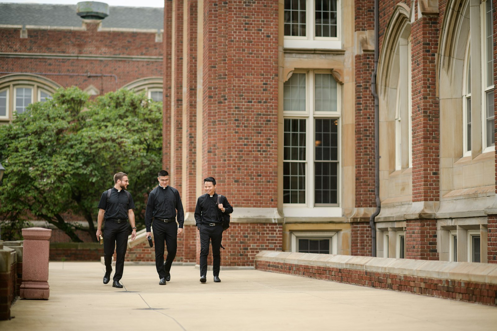 Seminarians walk the porch at Sacred Heart Major Seminary in Detroit. It typically takes seven or eight years for a man to be formed for priestly ministry, meaning there are no "quick fixes" to the vocation shortage, the archbishop said. Nevertheless, God will provide for the archdiocese's needs, he added. (Marek Dziekonski | Special to Detroit Catholic)