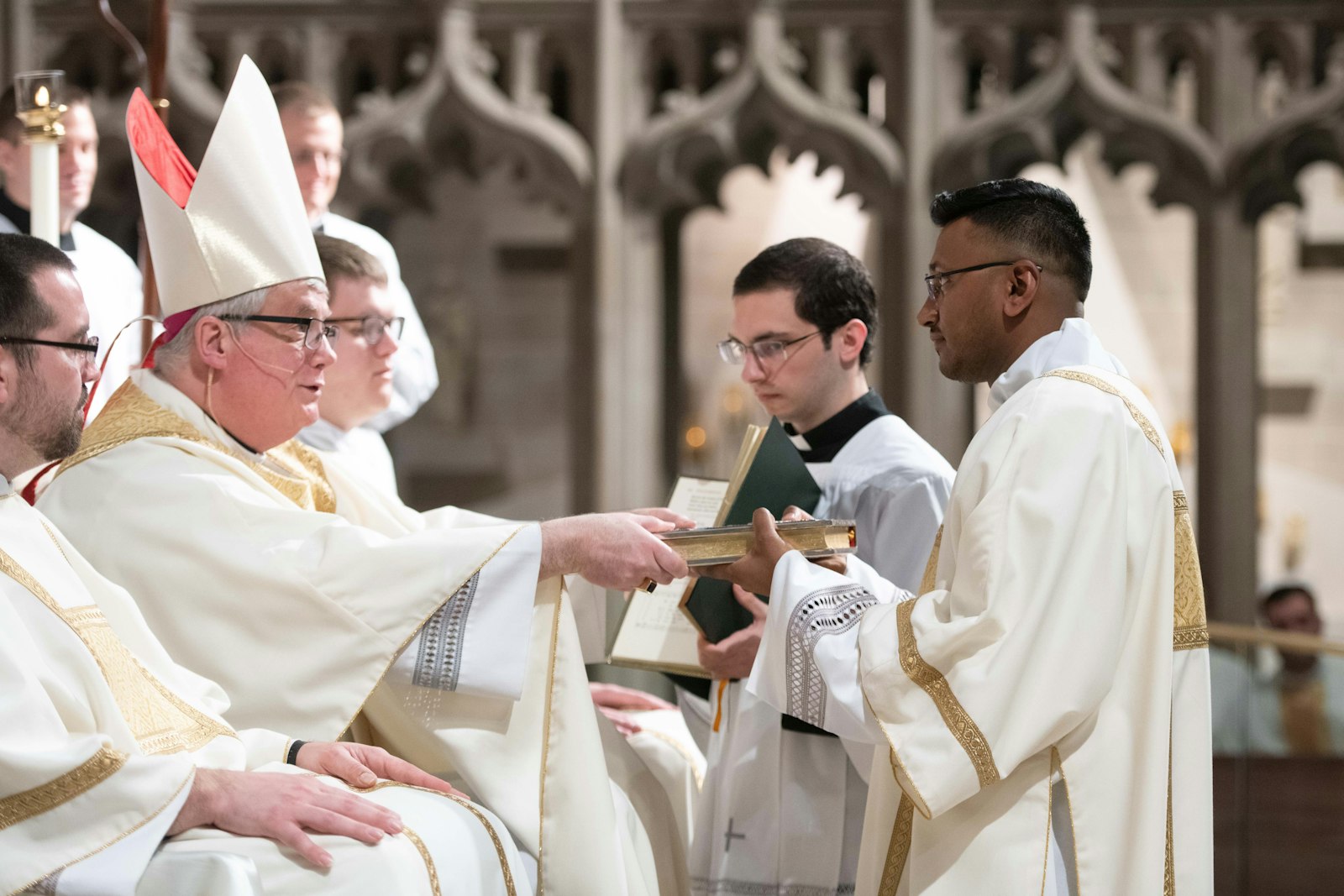 Bishop Battersby entrusts the book of the Gospels to then-Deacon Michael Bruno Selvaraj after ordaining him to the transitional diaconate April 23, 2022, at the Cathedral of the Most Blessed Sacrament in Detroit. (Tim Fuller | Special to Detroit Catholic)