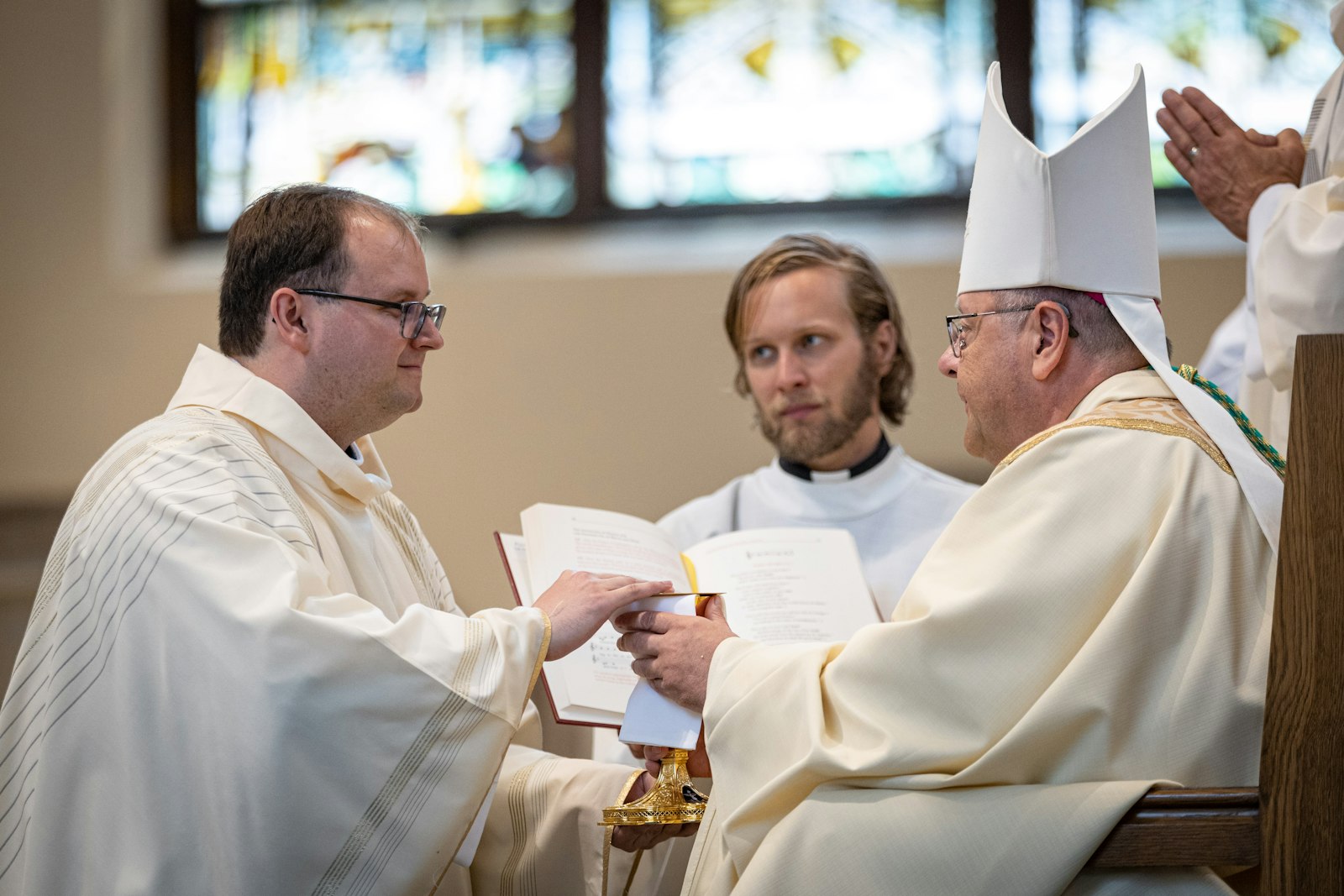 Fr. Daniel J. Kennedy kneels before Cleveland Bishop Edward C. Malesic during the Rite of Ordination on June 10 at the Church of the Gesu in Milwaukee. (Steve Donisch | Special to Detroit Catholic)