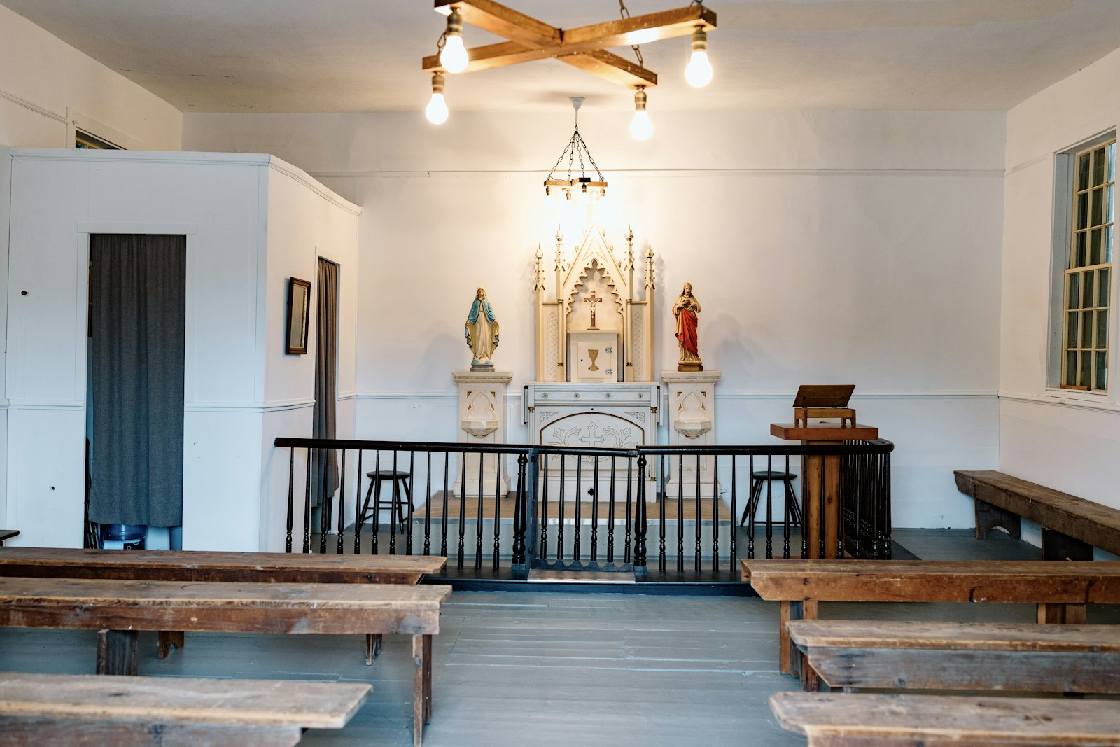 The chapel's original baptismal font, Stations of the Cross and confessional still stand, as well as small wooden pews built to serve the Irish farming families who would attend Mass there.