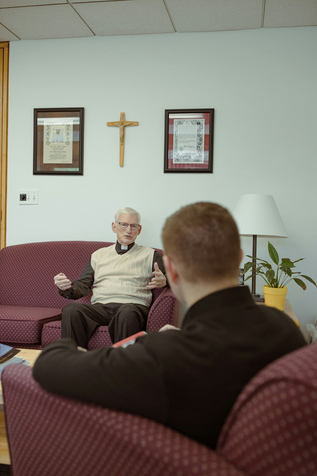 Fr. Nowak, right, interviews Msgr. McEnhill for a class assignment. Fr. Nowak is taking online courses toward a master's in business administration from the University of Mary in North Dakota.