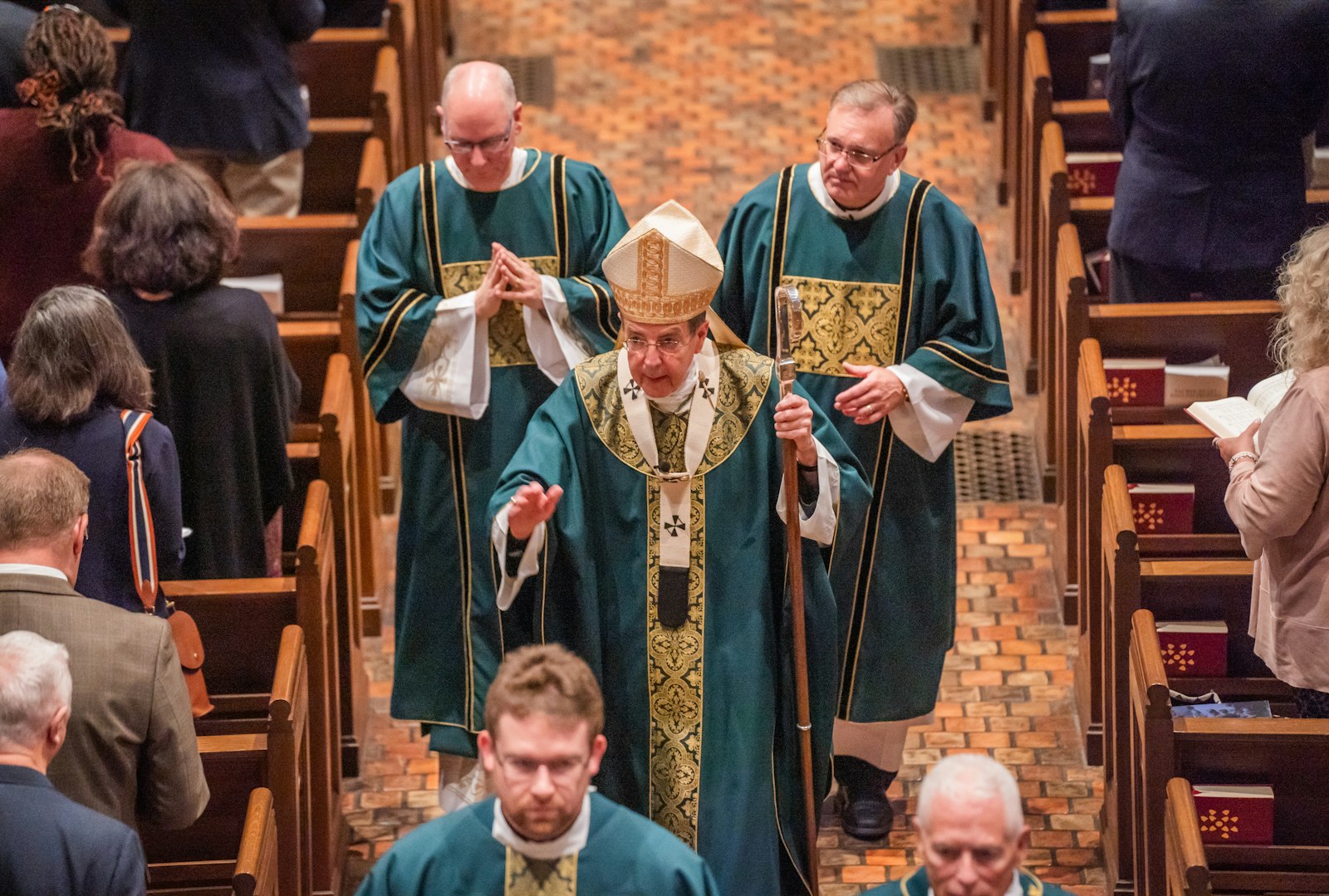 Archbishop Allen H. Vigneron processes into Sacred Heart's chapel with fellow clergy during the 30th annual Mass for Commerce.