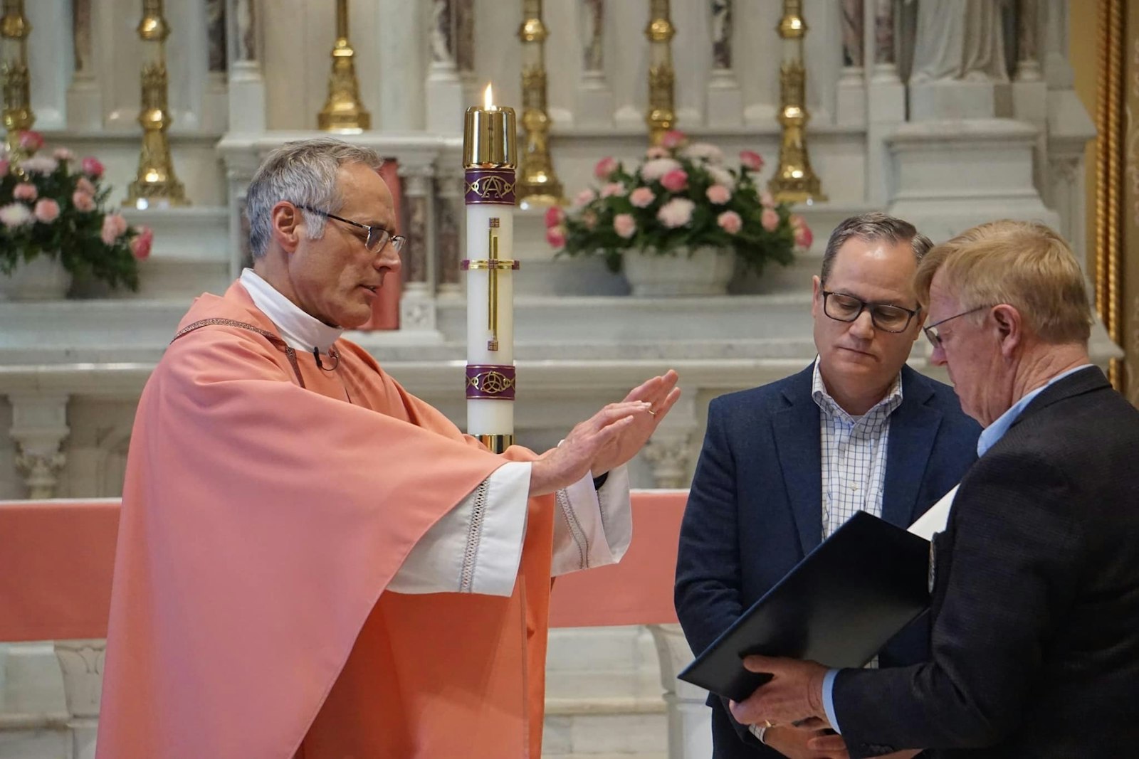 Fr. Jim Bilot, chaplain of the newly chartered Detroit-Northeast Serra Club, prays over new officers March 19 at St. Paul on the Lake. Fr. Bilot, who served as vocations director for the archdiocese from 2000 to 2007, said he hopes the club can help introduce young people to a better understanding of their faith and vocations.