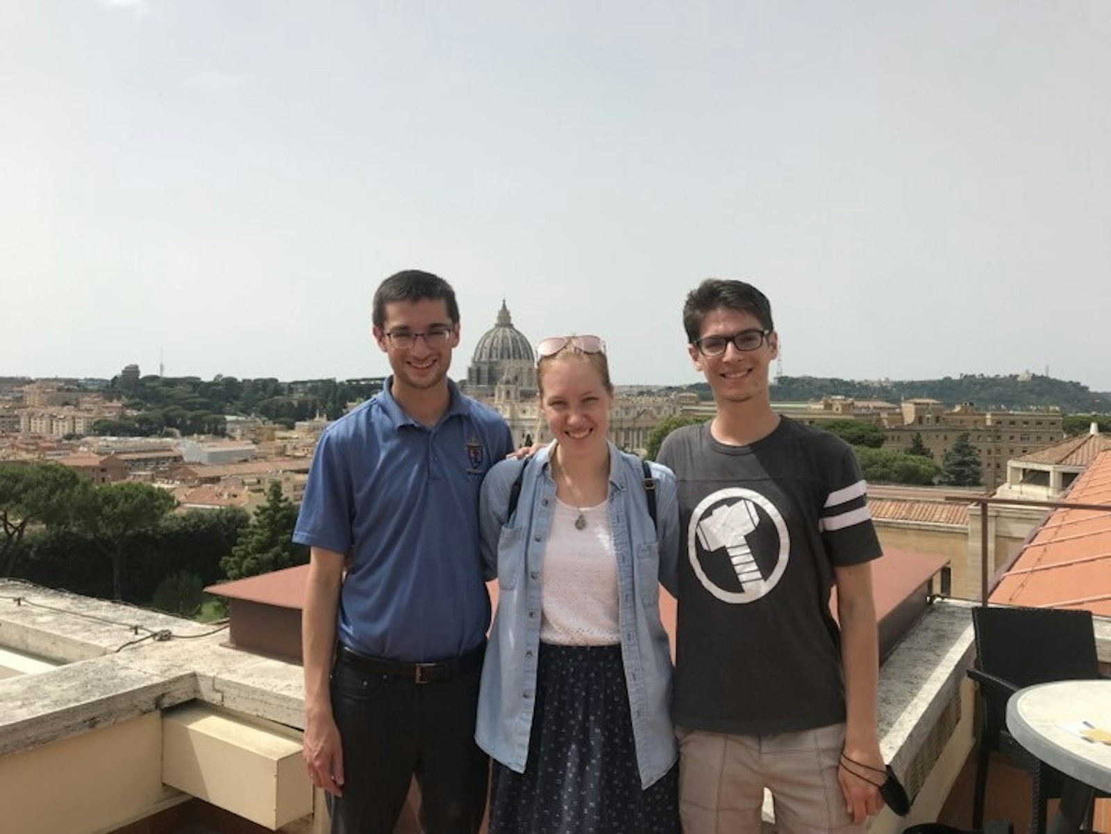 Ryan Asher, left, stands on the roof of the Pontifical North American College with his brother and a cousin. Asher said the rooftop is one of his favorite places in the city to pray.