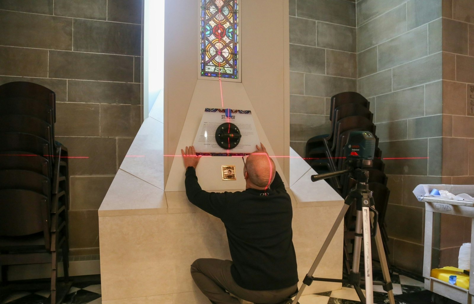 Keith Calleja began installation of relics on Jan. 8, 2024, starting with the relic of St. Philip. Here, he installs a placard above the relic of St. Peter.